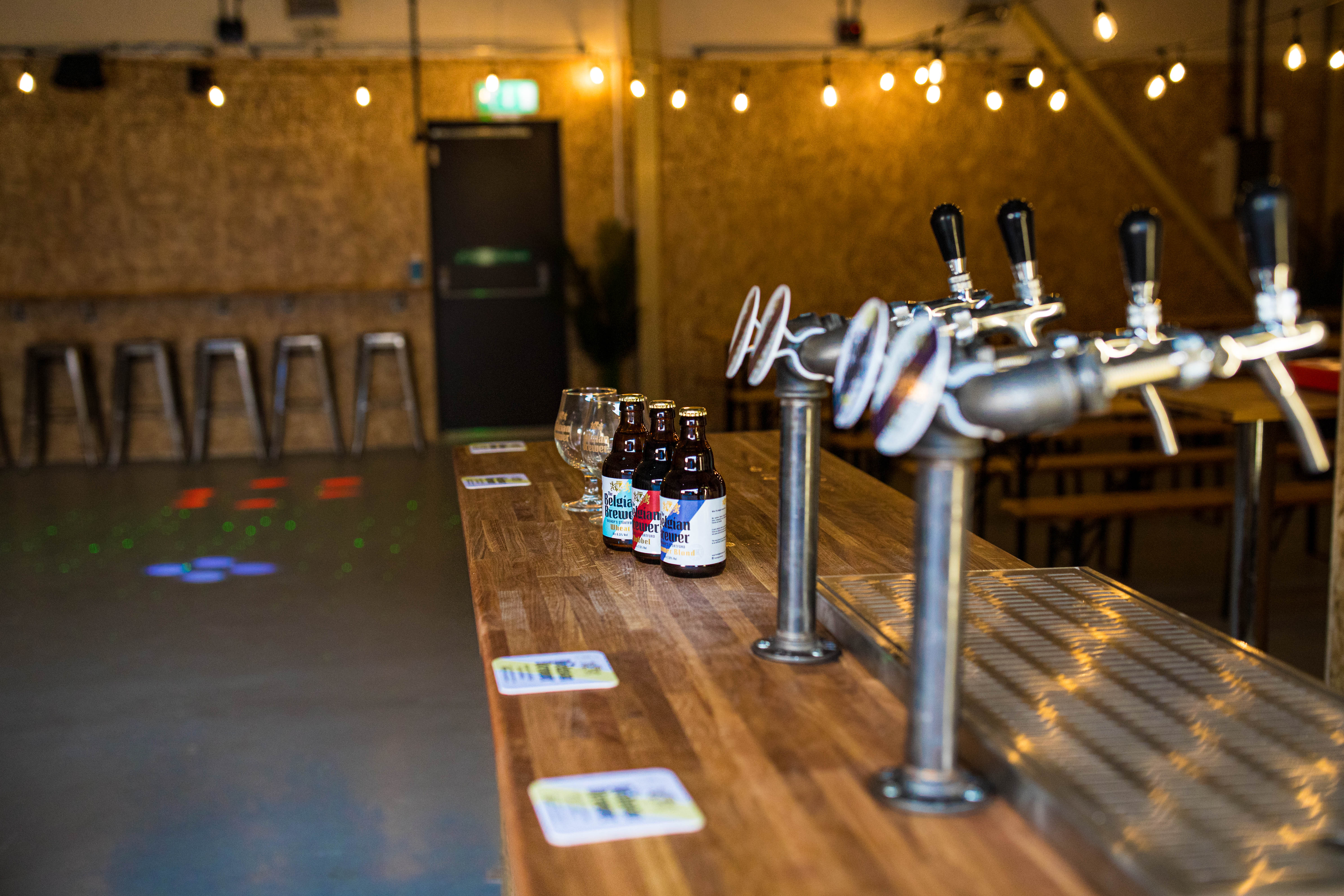 Stylish bar setup with polished wood at The Belgian Brewer Event Hall for gatherings.