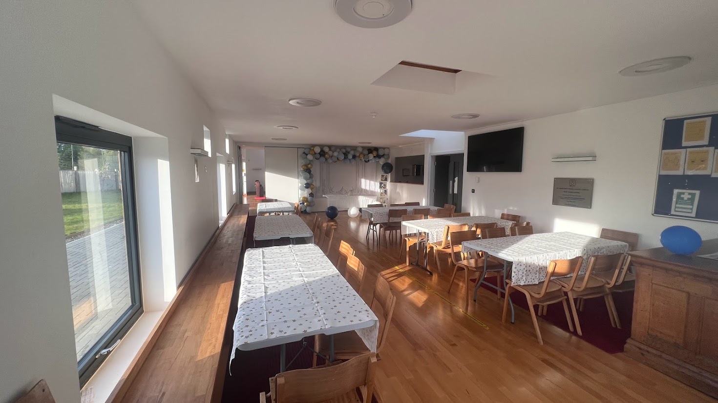 St James Mar Thoma Church Hall with wooden flooring, ideal for events and gatherings.