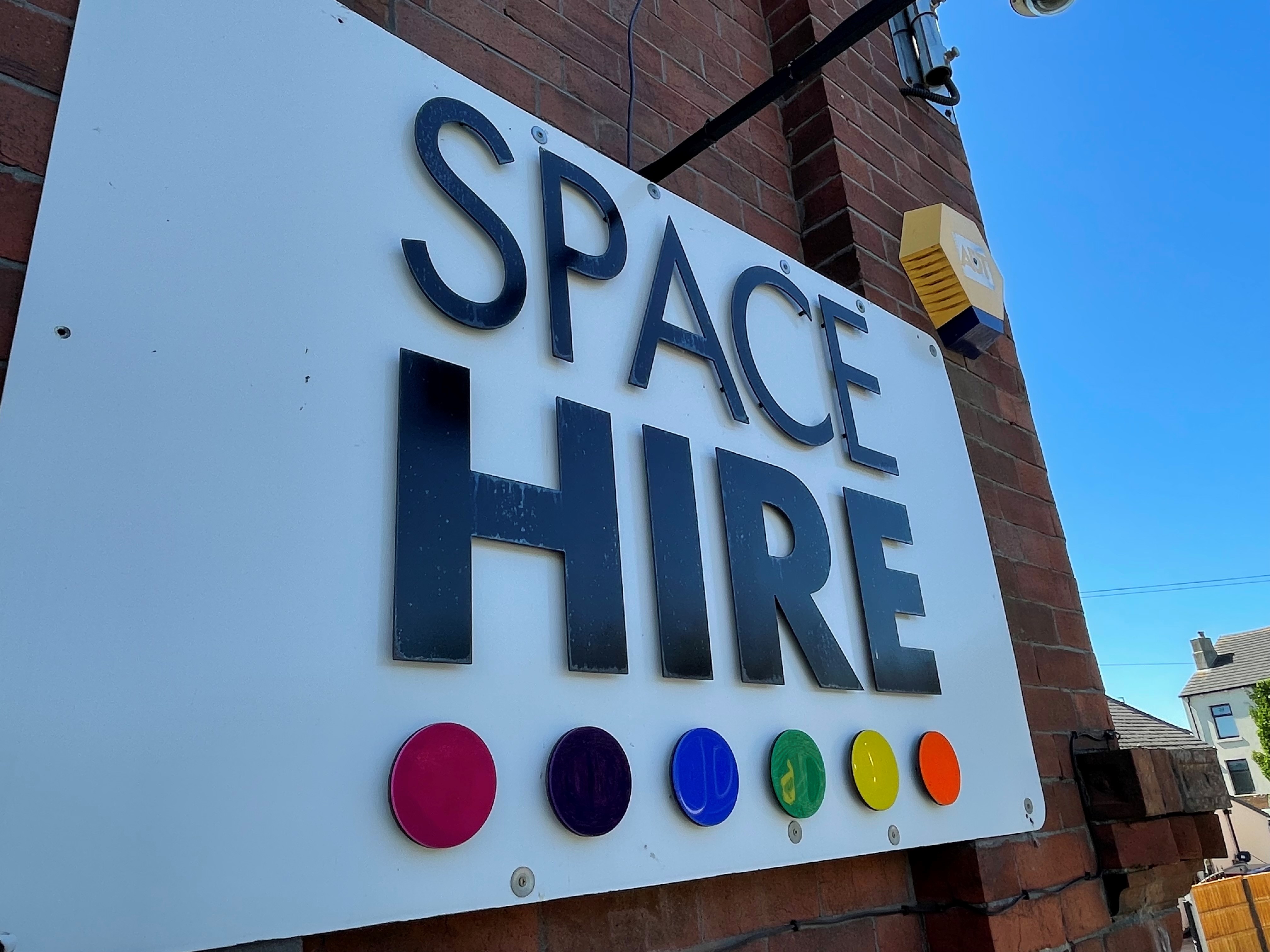 "Space Hire venue sign with bold lettering for versatile event spaces."
