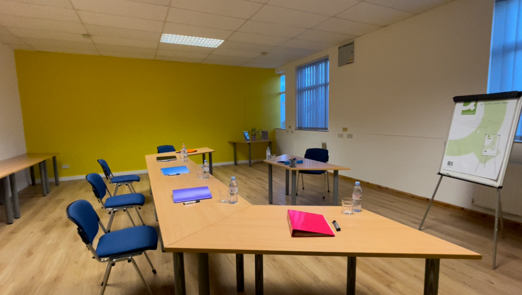 Bright yellow meeting room for collaborative discussions and brainstorming sessions.