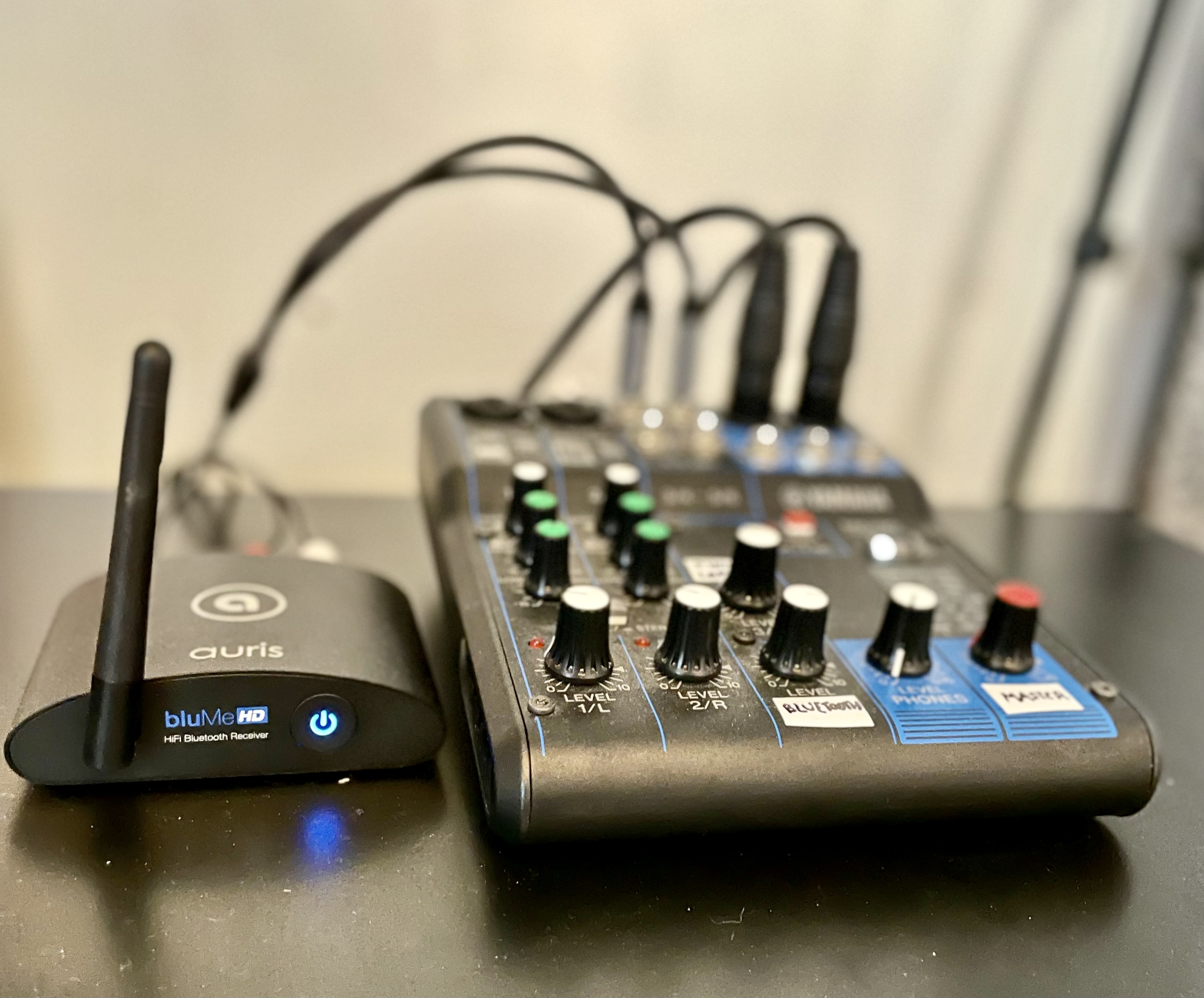 Audio equipment setup with Bluetooth transmitter and mixer for seamless event presentations.