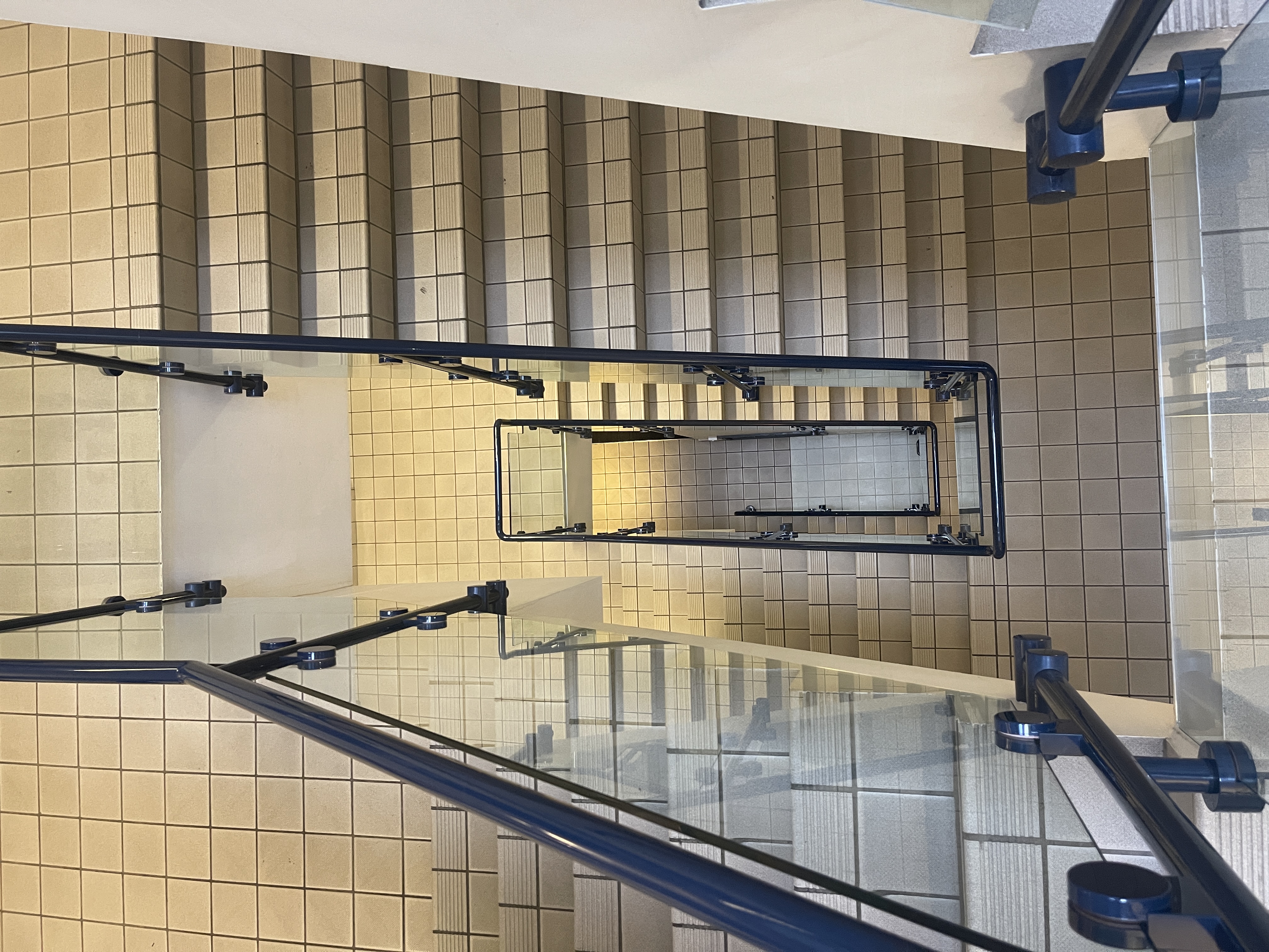 Well-maintained staircase with glass railing in HQ1, ideal for events and meetings.