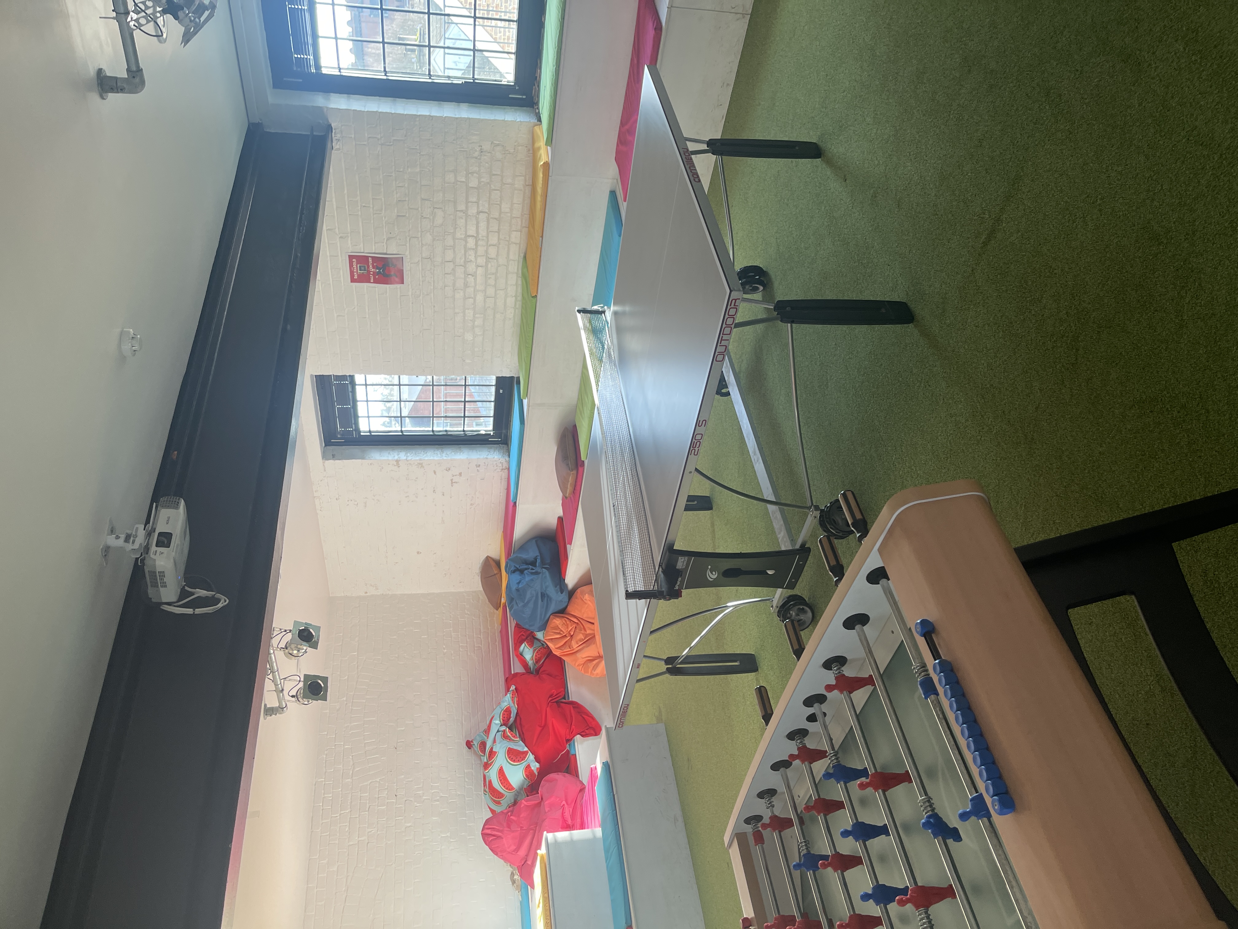 Vibrant HQ1 meeting space with ping pong table for creative team collaboration.