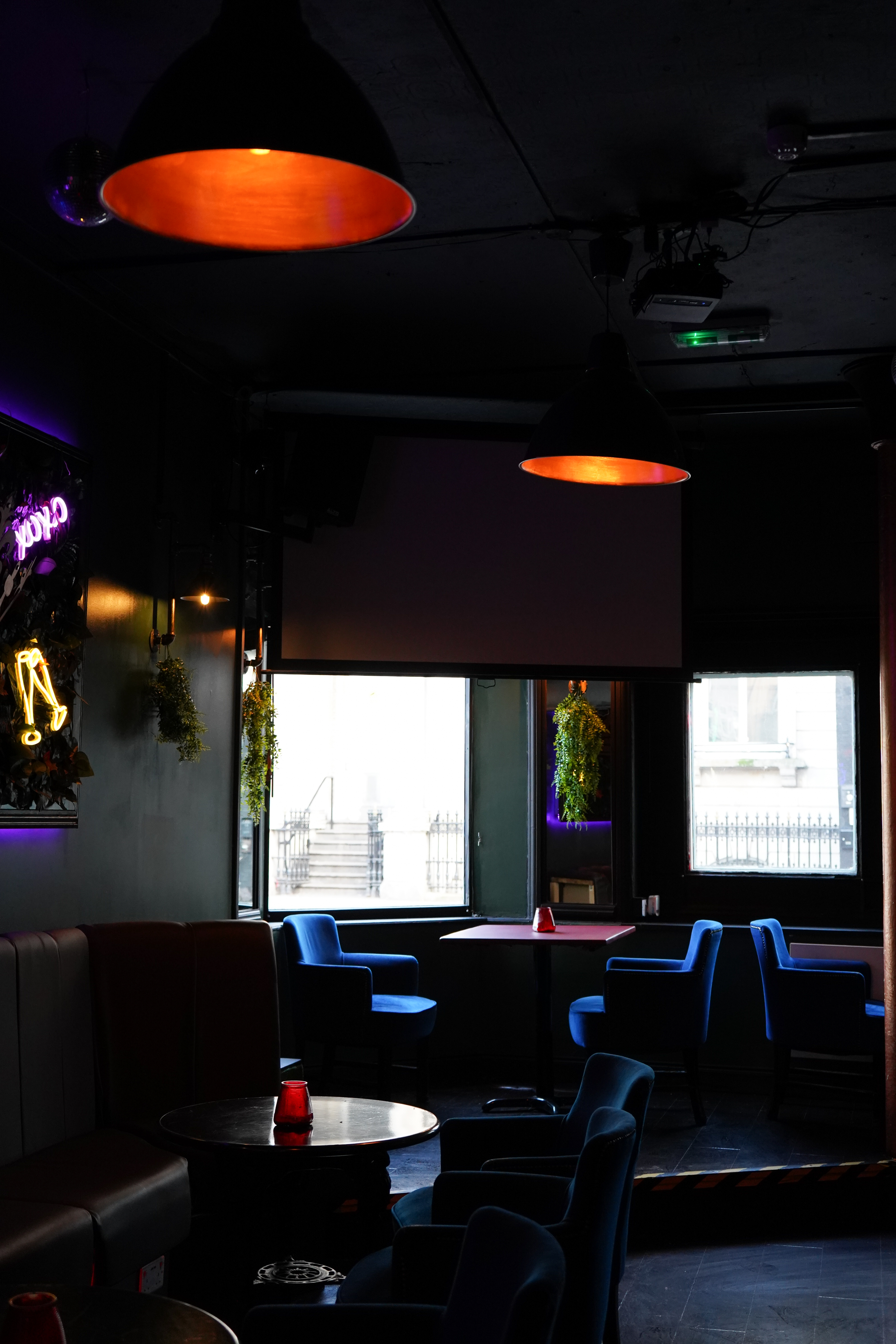 Modern event space at TKL with large screen, ideal for workshops and networking.