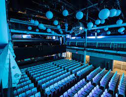Modern event space at Terminal 5 with tiered seating for conferences and performances.