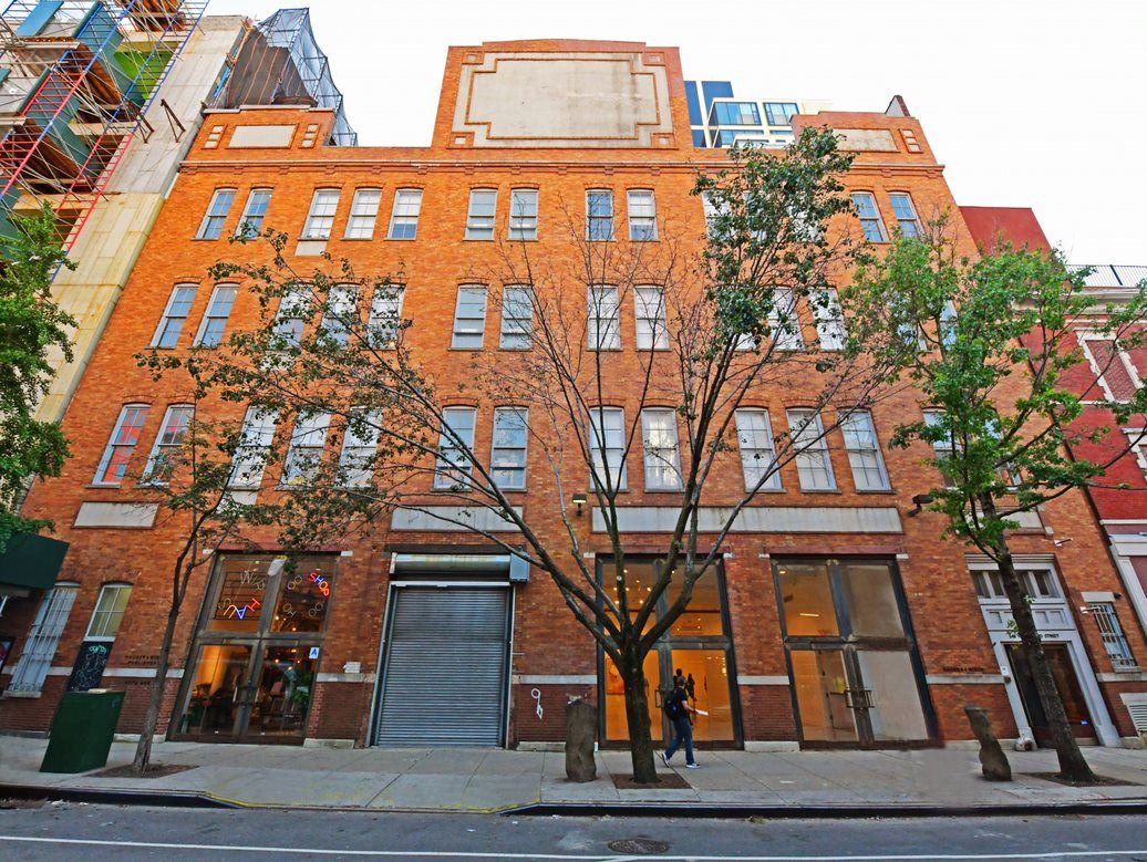 Charming brick venue with large windows for meetings and events in urban setting.