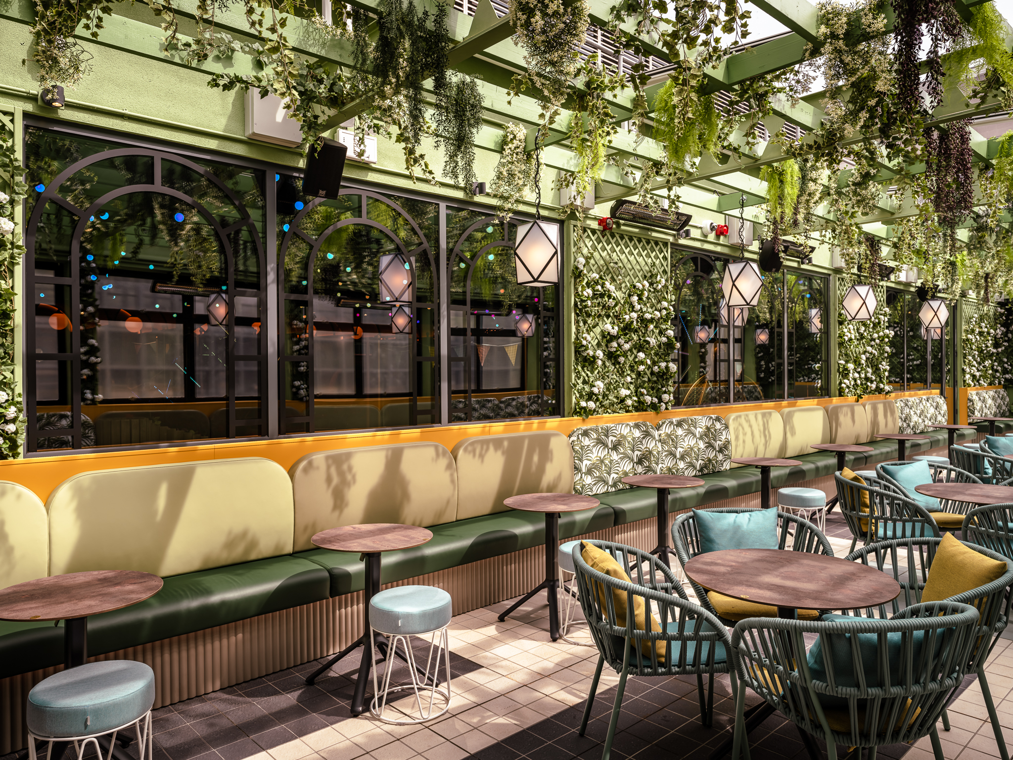 Vibrant greenery venue with stylish seating for meetings and events at Swingers West End.