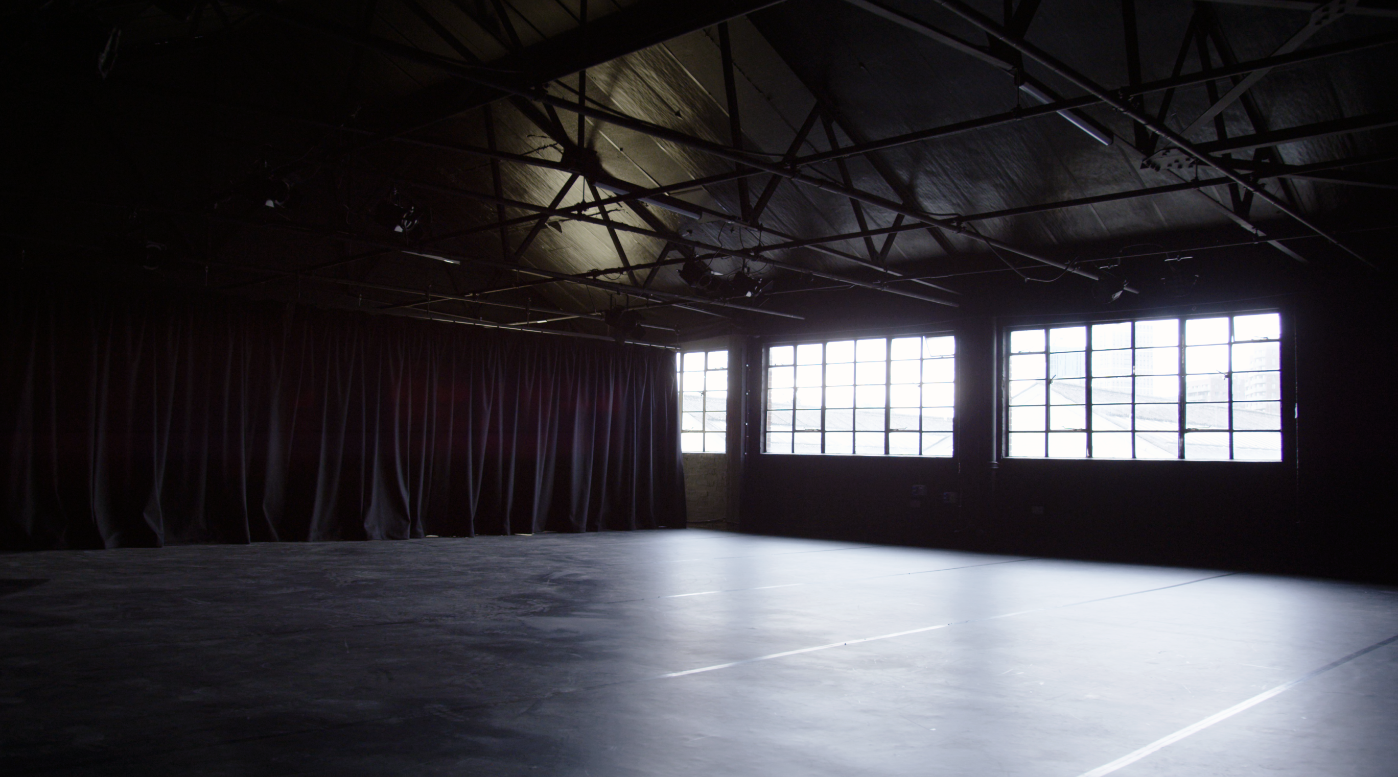 Versatile industrial event space with large windows in Klatch Studio's Black Box.