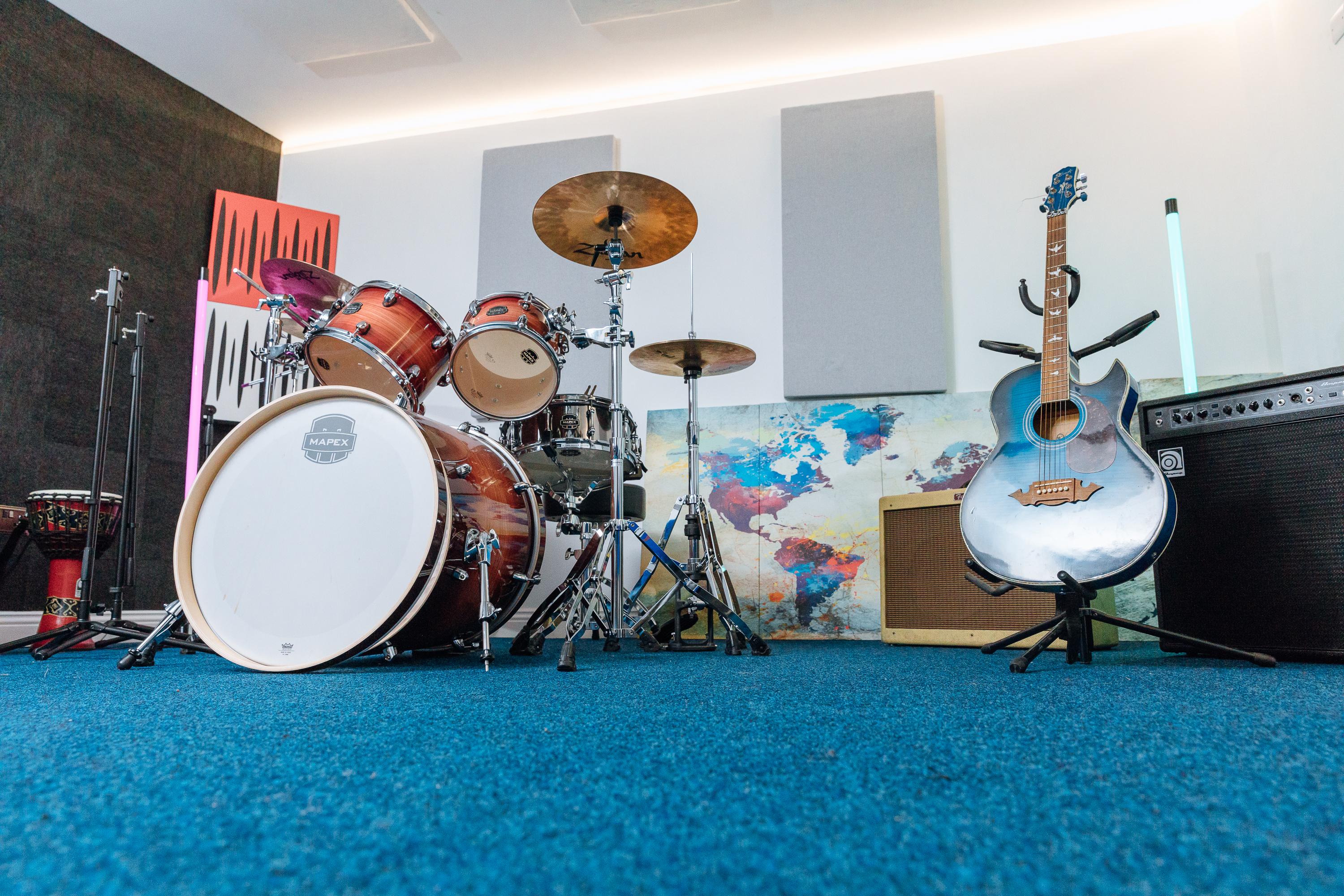 Vibrant recording studio with drum set, ideal for music workshops and team-building events.