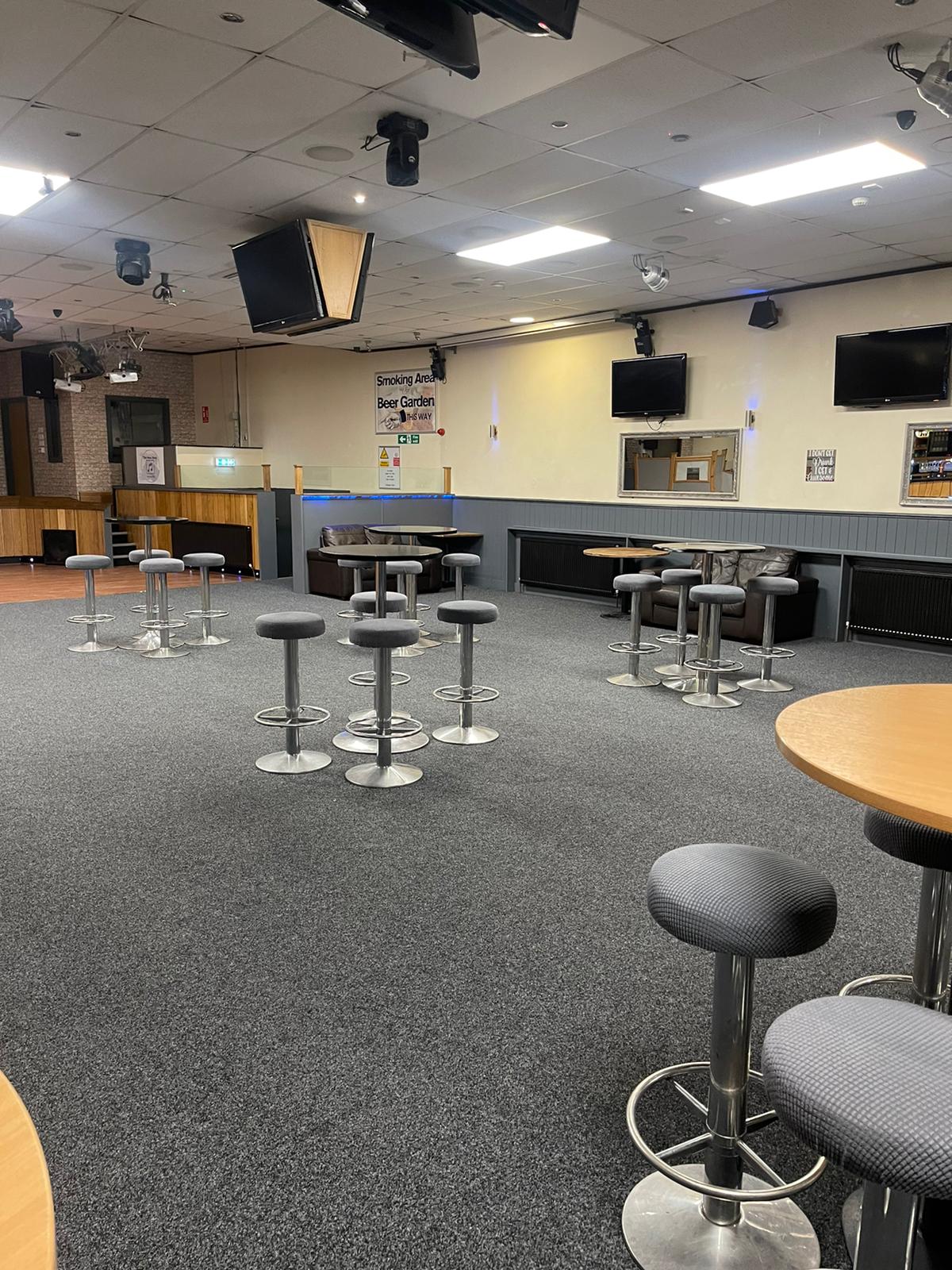 Versatile event space with high-top tables for networking and gatherings at The New Roxy.