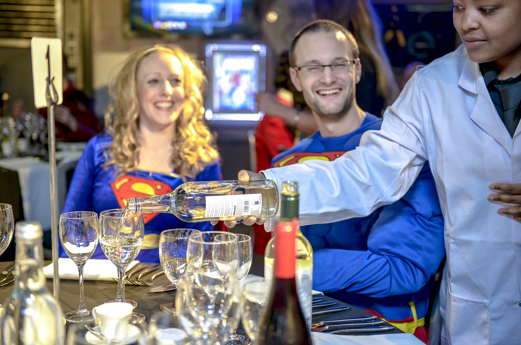 Superhero-themed event at Madame Tussauds with elegant table setting and lively atmosphere.
