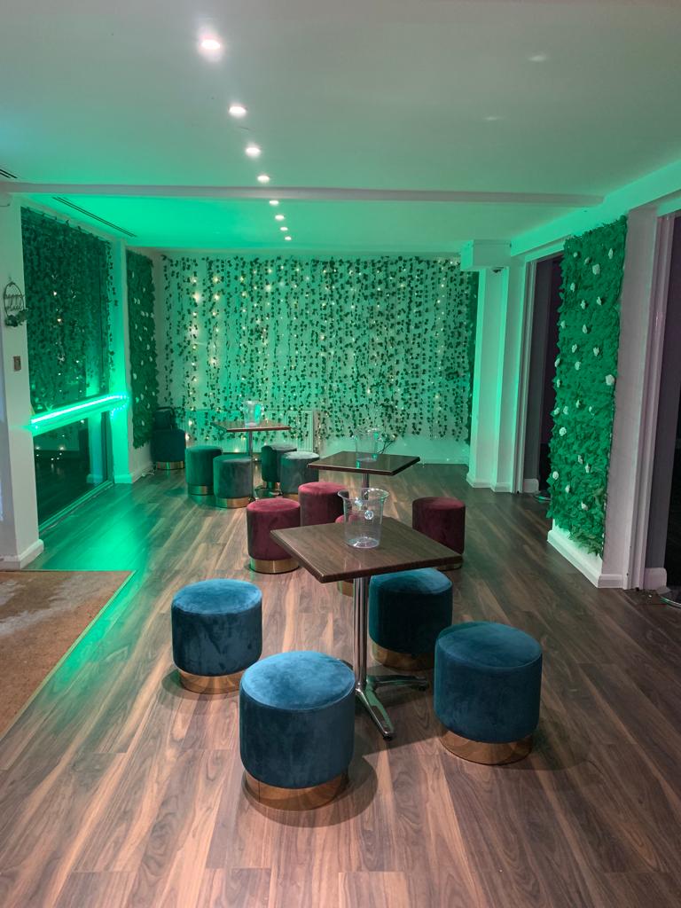 Stylish Banquet Hall with green decor, ideal for intimate gatherings and networking events.