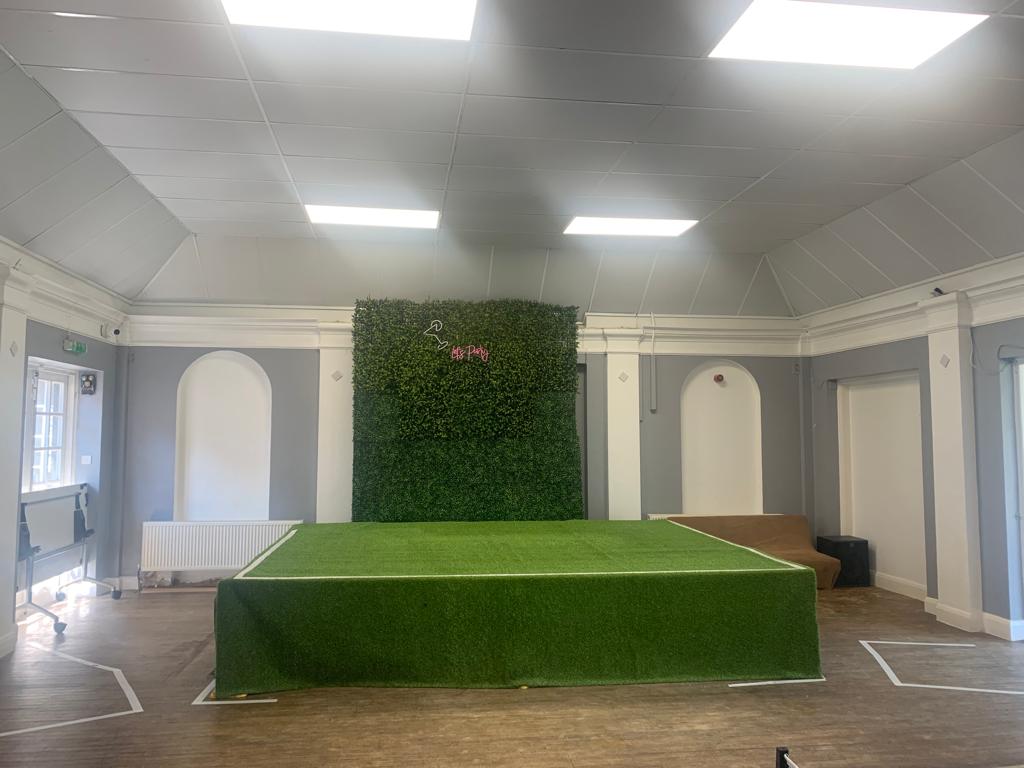 Banquet Hall in The Garden of Lewisham with raised stage, ideal for events and workshops.