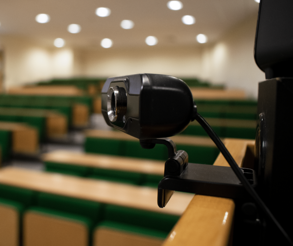 BCOM Lecture Theatre with green seating, ideal for hybrid events and presentations.