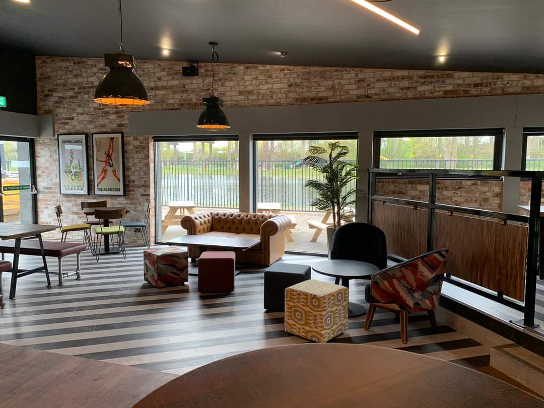 Event Hire in Powerleague Birmingham: modern meeting space with cozy seating for networking.