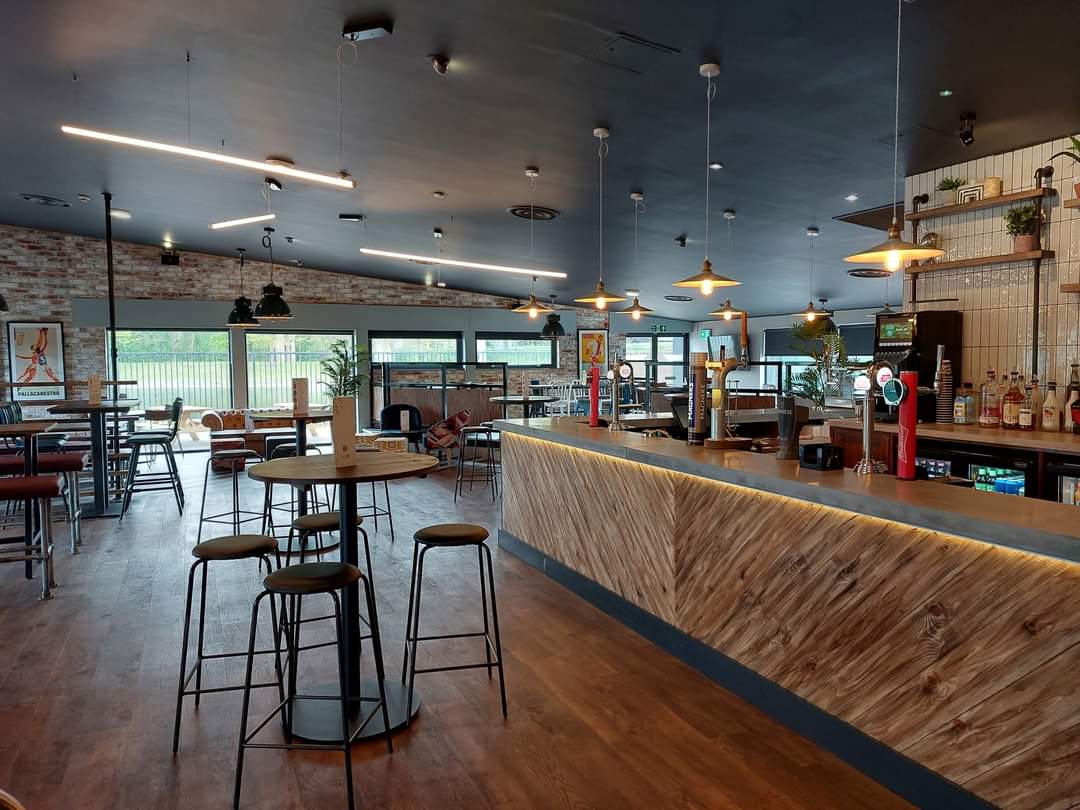 Modern event venue in Powerleague Birmingham with stylish bar for casual meetings.