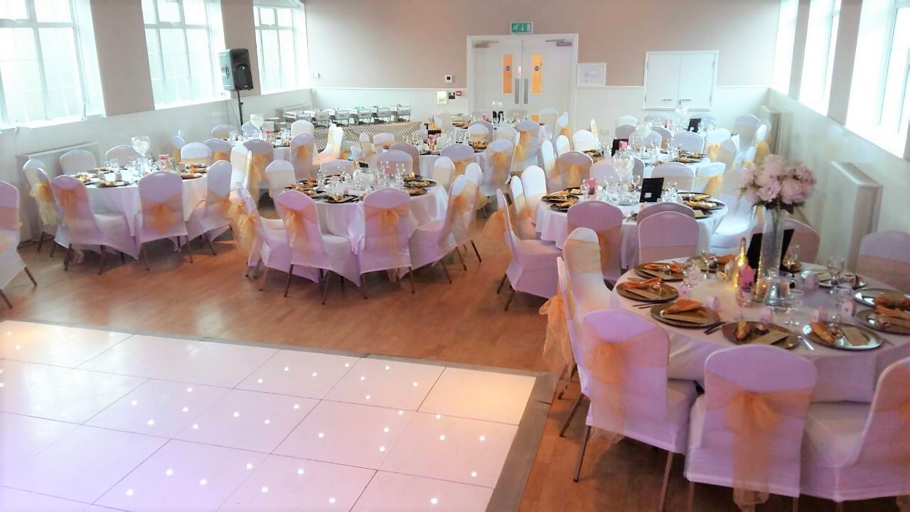 Elegant event space with round tables, perfect for weddings or corporate gatherings.