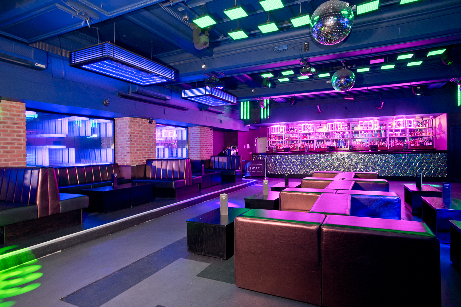 Vibrant nightlife event space with modern seating and dynamic lighting in Sway.