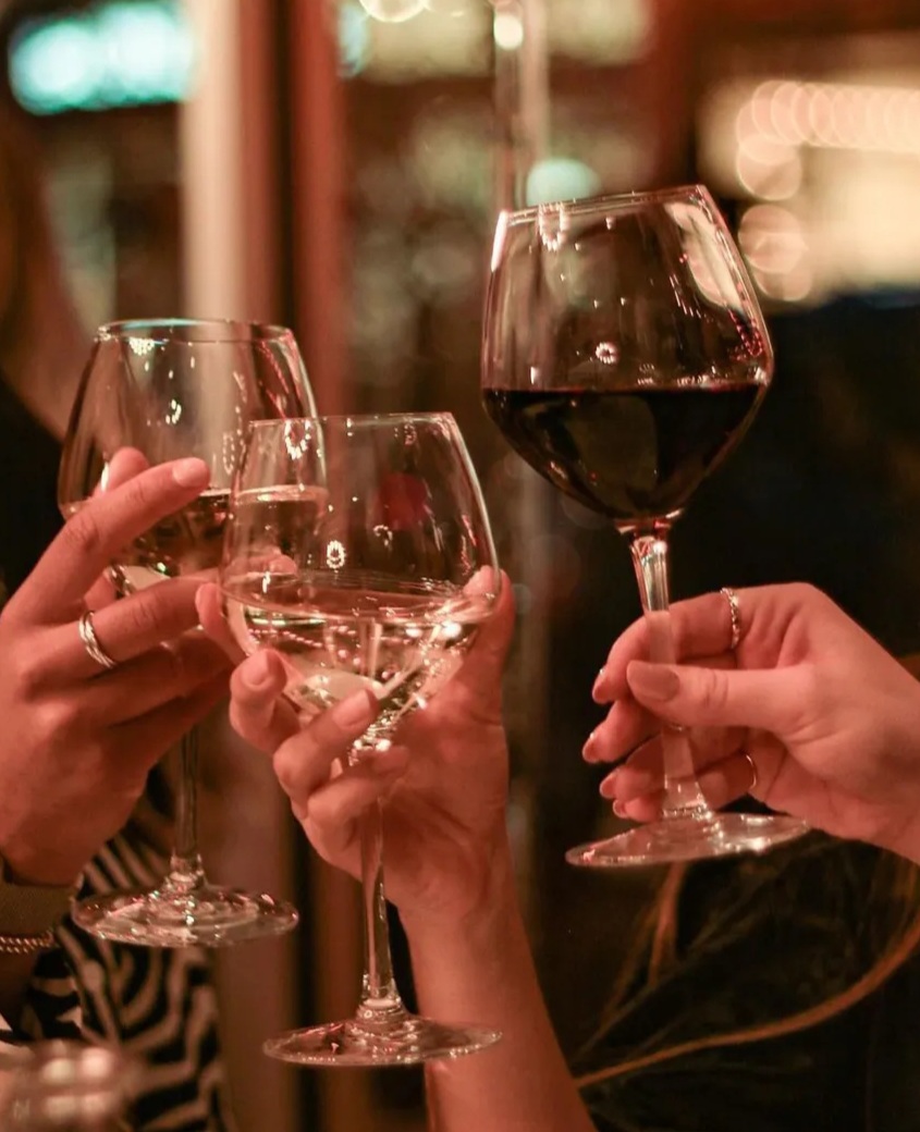 Private dining room at The New Roxy, showcasing networking event with clinking glasses.