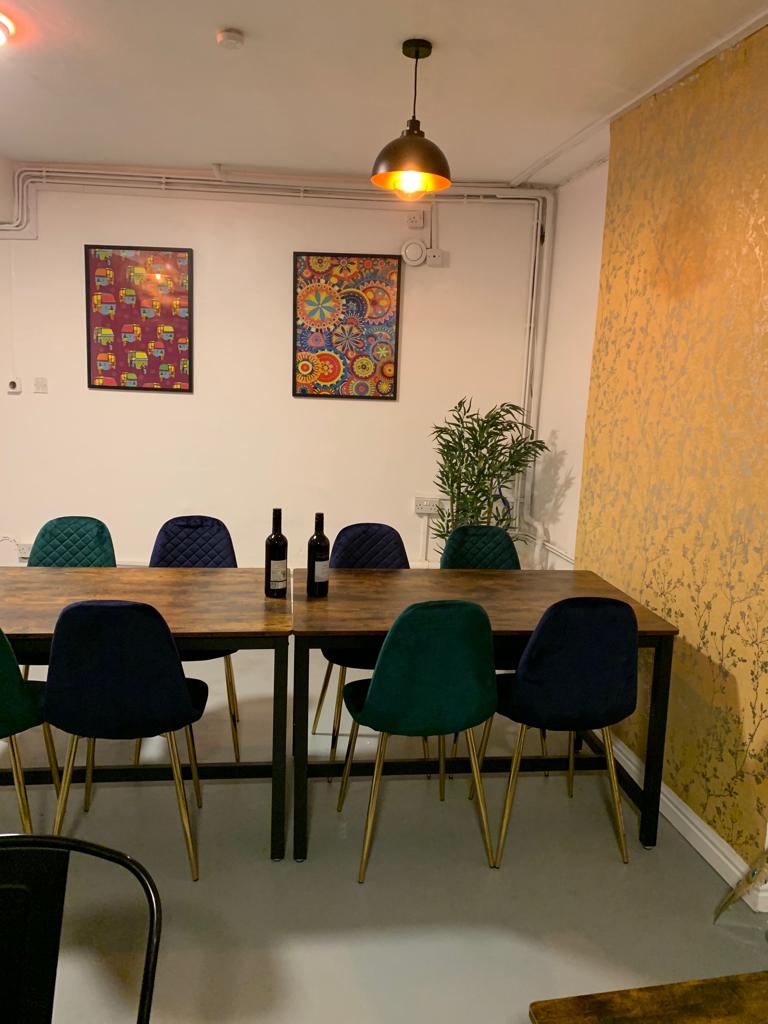 The India Room at Biryani Pot: stylish meeting space with wooden table, ideal for events.