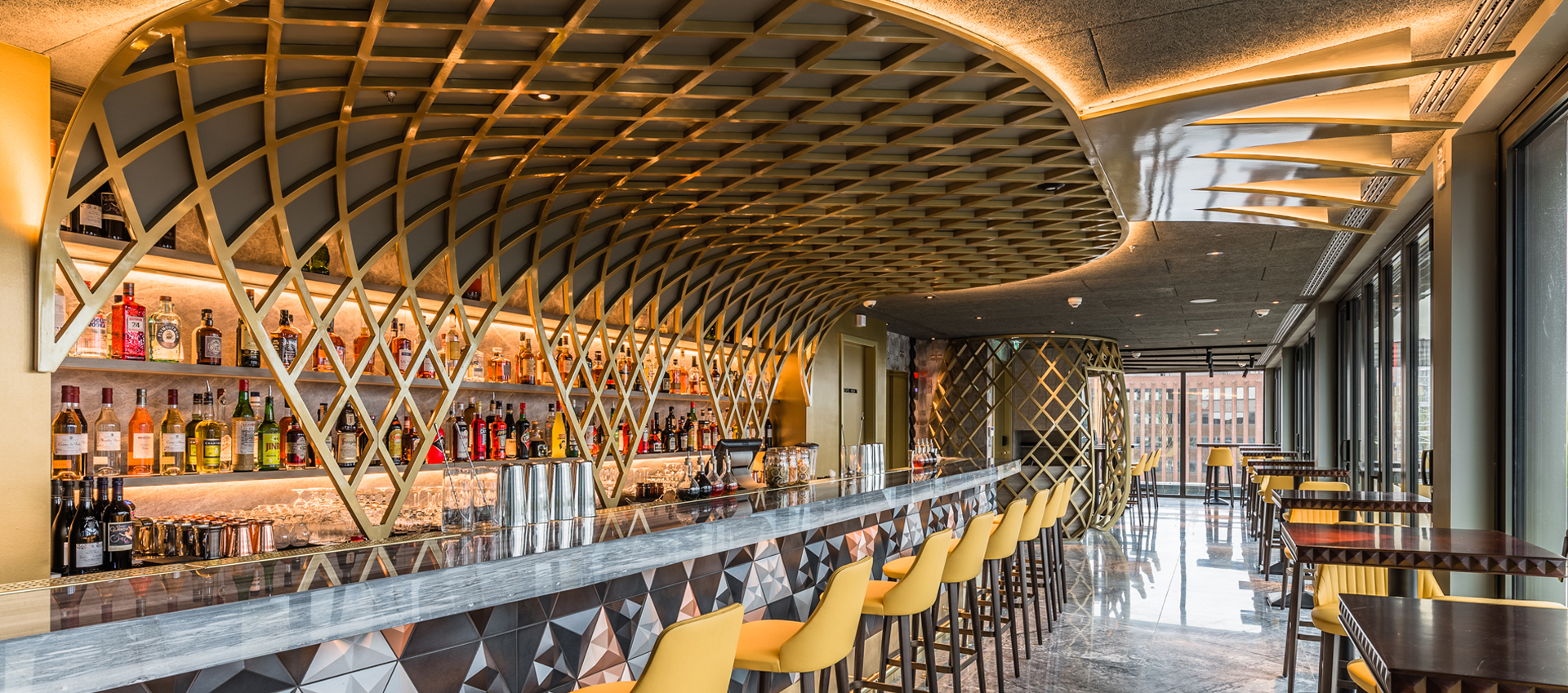 Semi-private hire at Jin Bo Law, featuring a sleek bar and geometric ceiling for cocktail receptions.