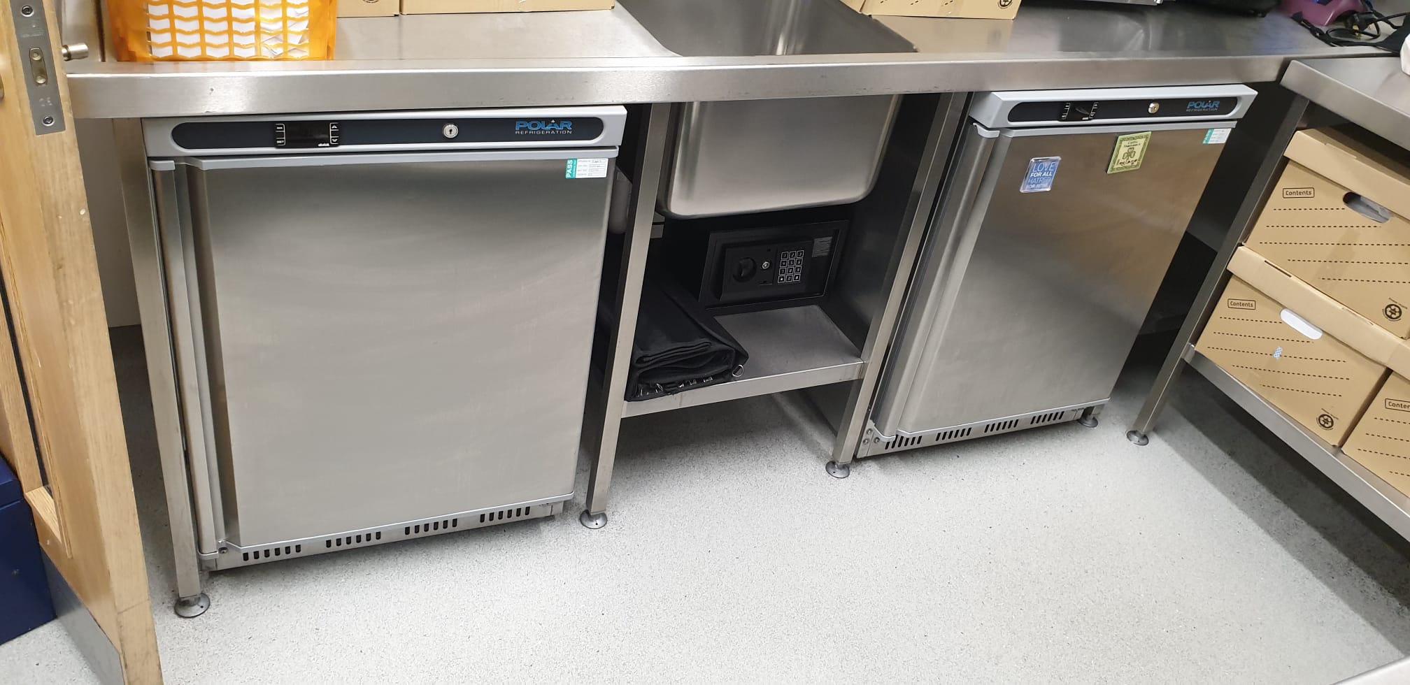 Eden Cafe Kitchen Hire: sleek stainless steel kitchen with under-counter fridges for events.