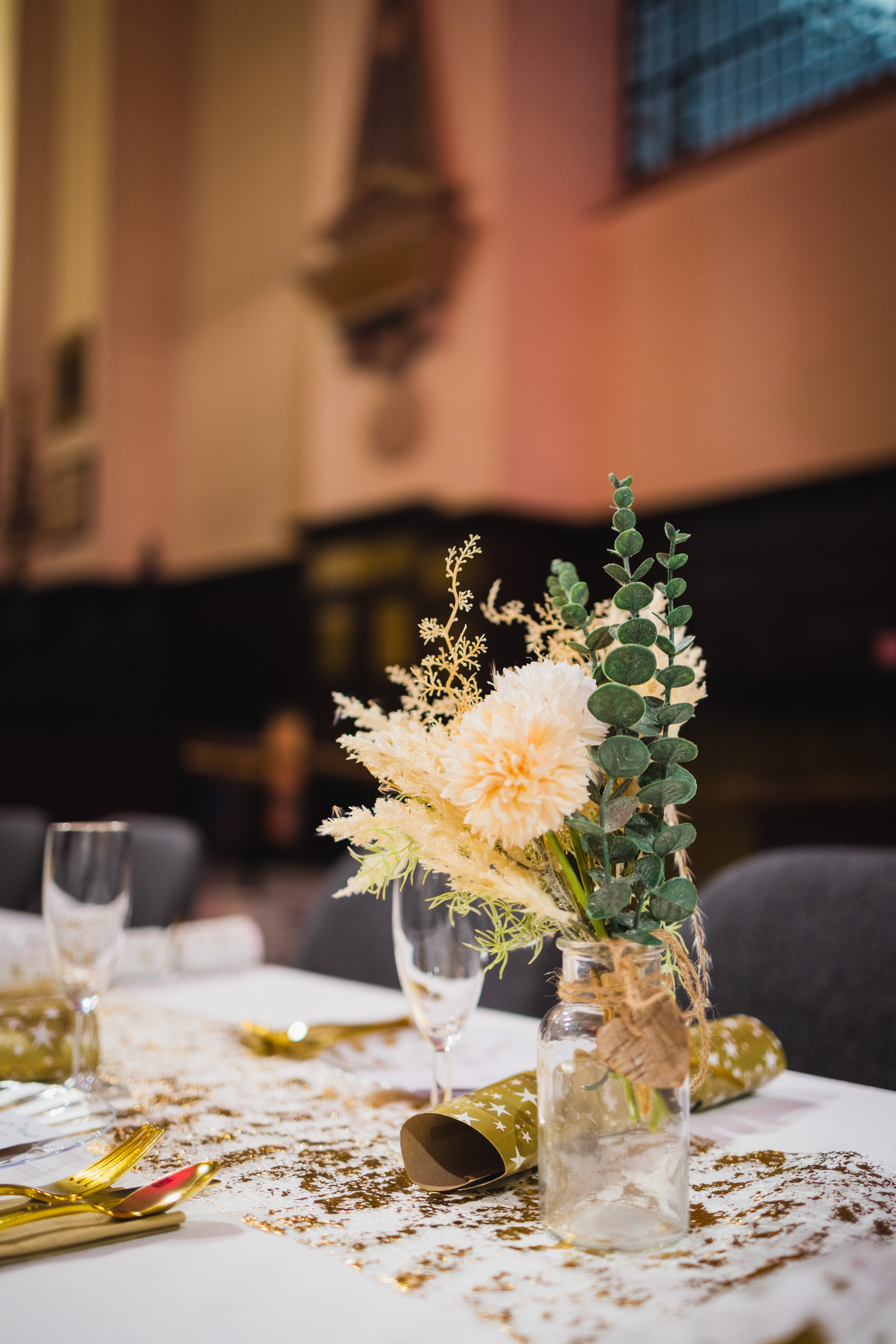 Floral centerpiece in St Edmund the King for elegant events, featuring soft tones and greenery.