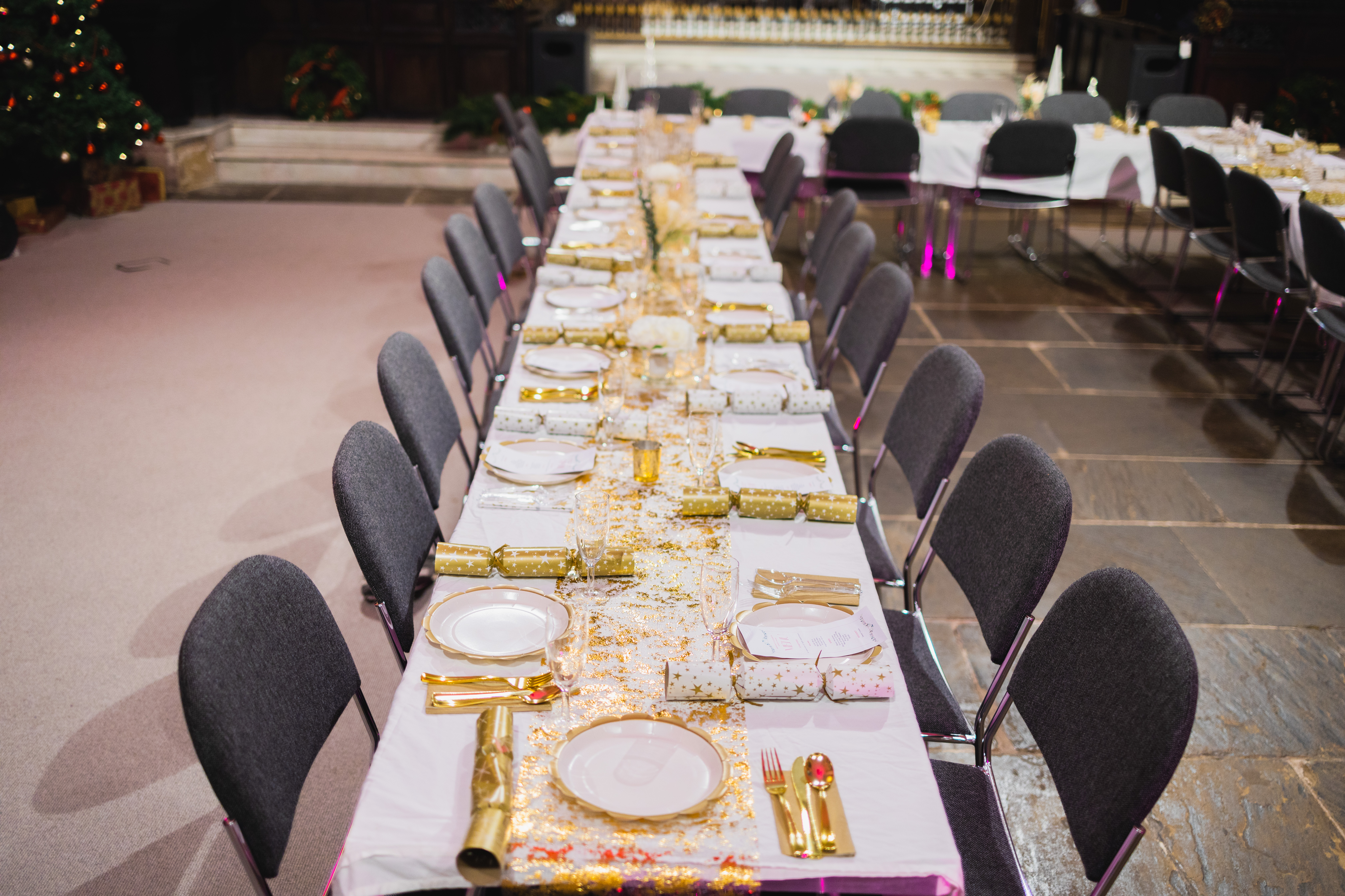 Elegant banquet table in St Edmund the King for festive events, featuring gold accents.