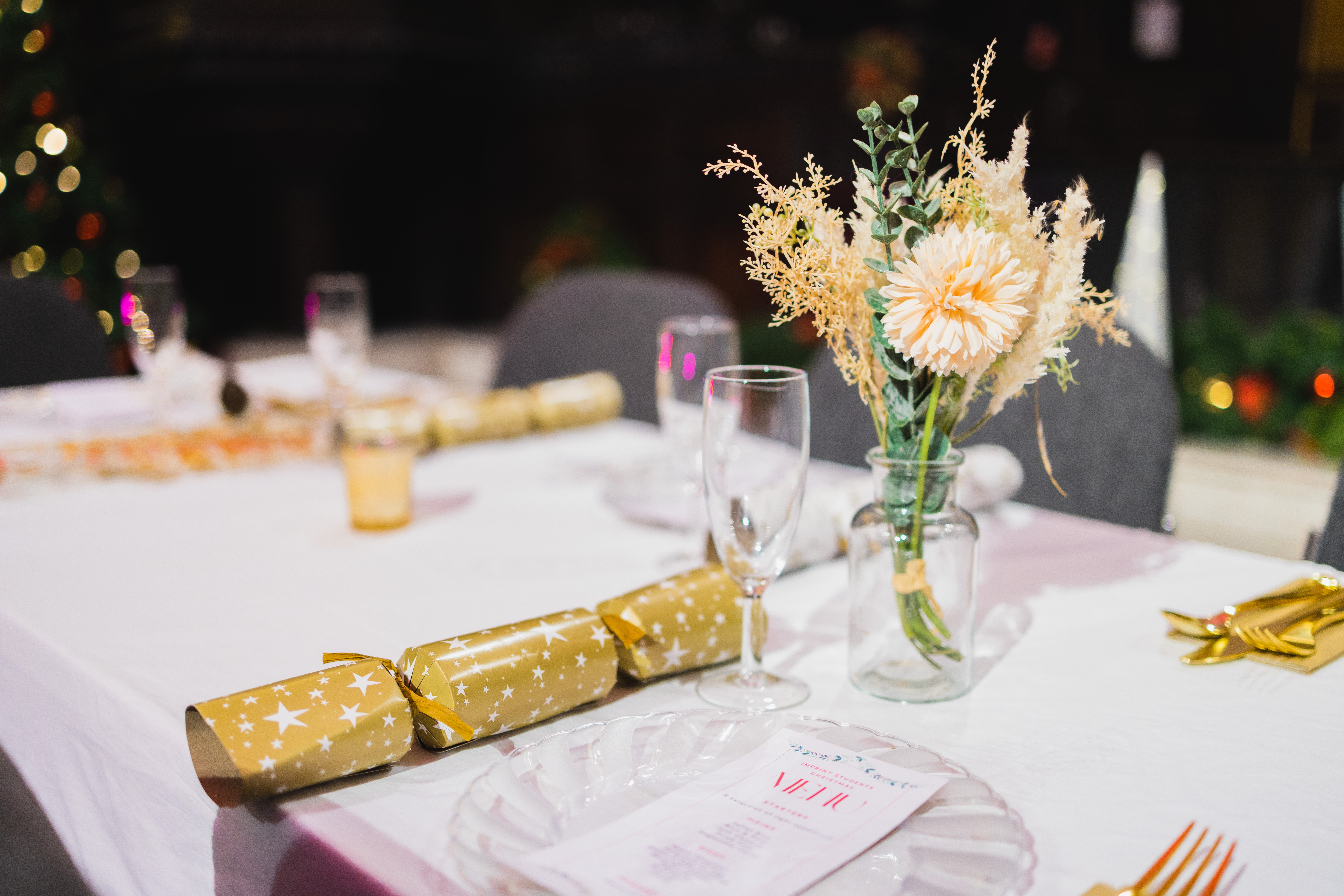 Elegant table setting with floral centerpiece for holiday gatherings at St Edmund the King.