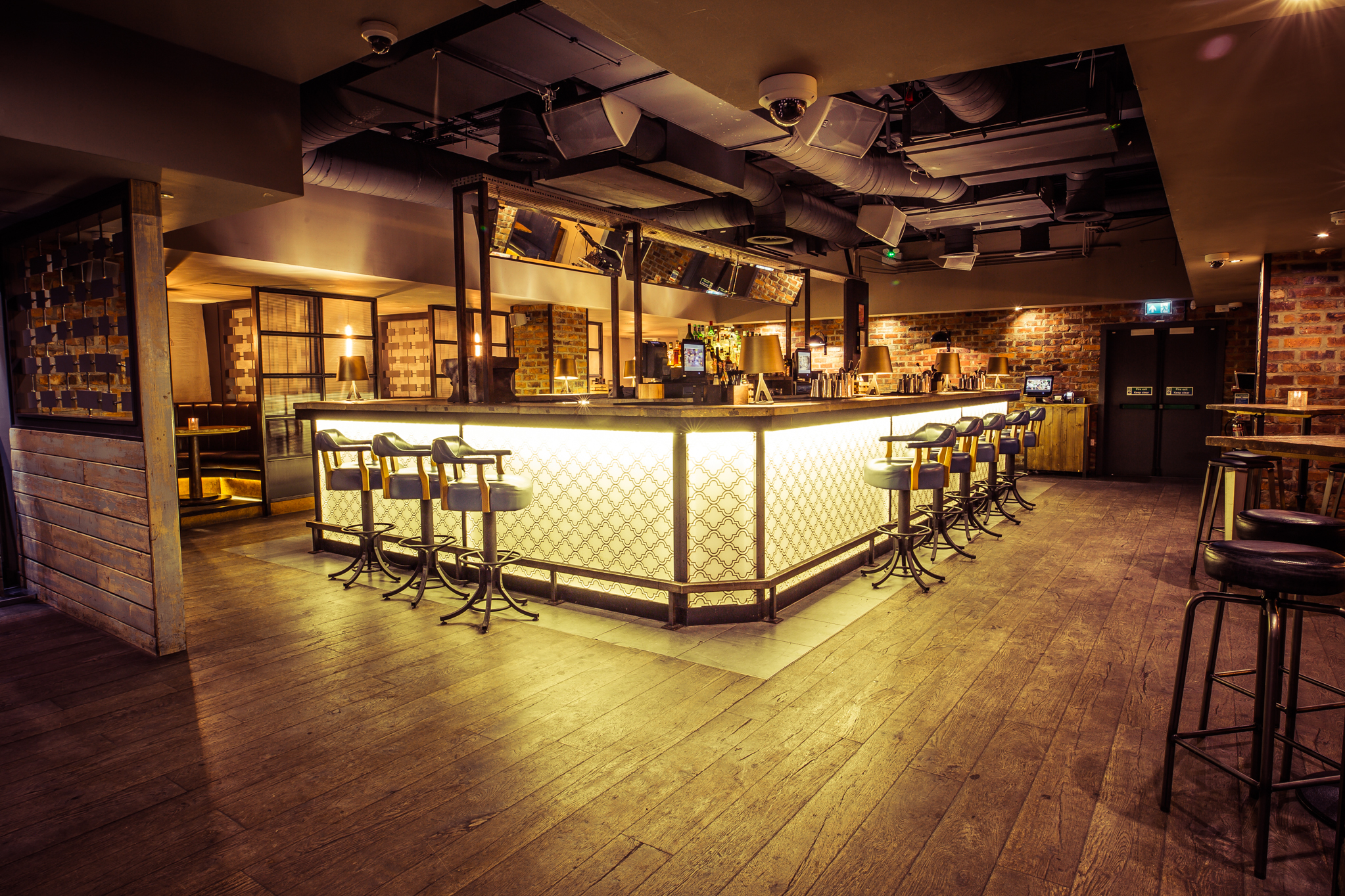 Stylish bar setup with warm lighting for networking and social gatherings in Basement, Forge.