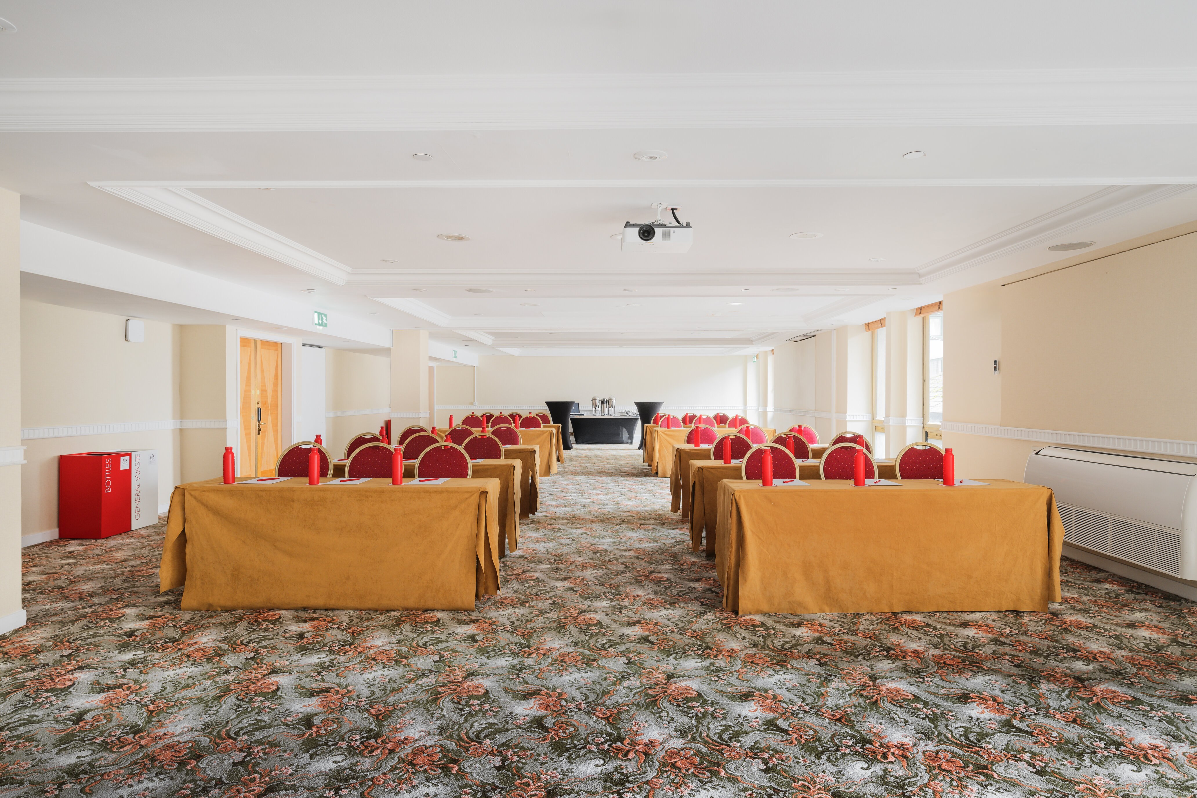Kensington Suite meeting room with red chairs, ideal for conferences and seminars.