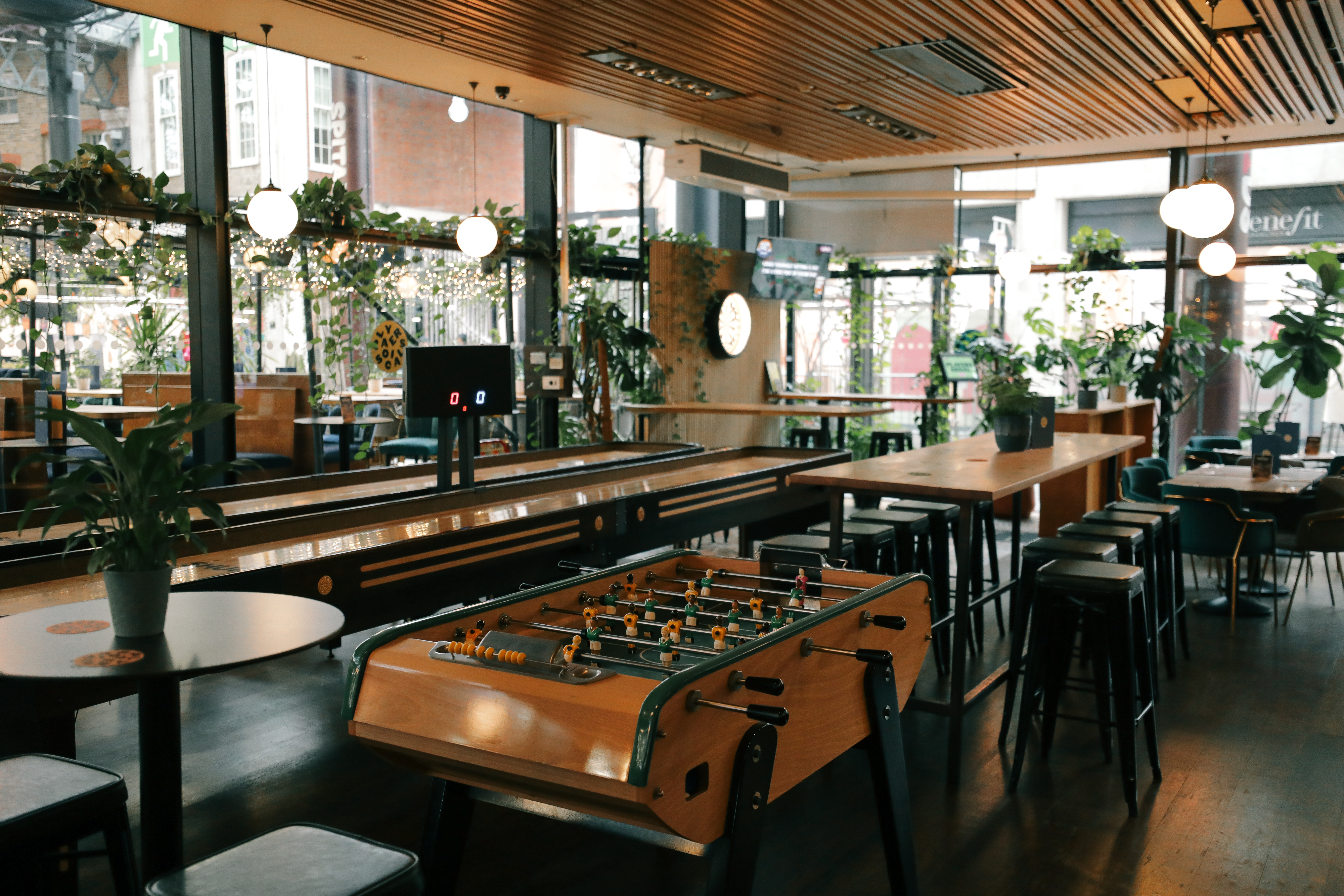 Players Social breakout space with communal tables for team building and corporate networking.