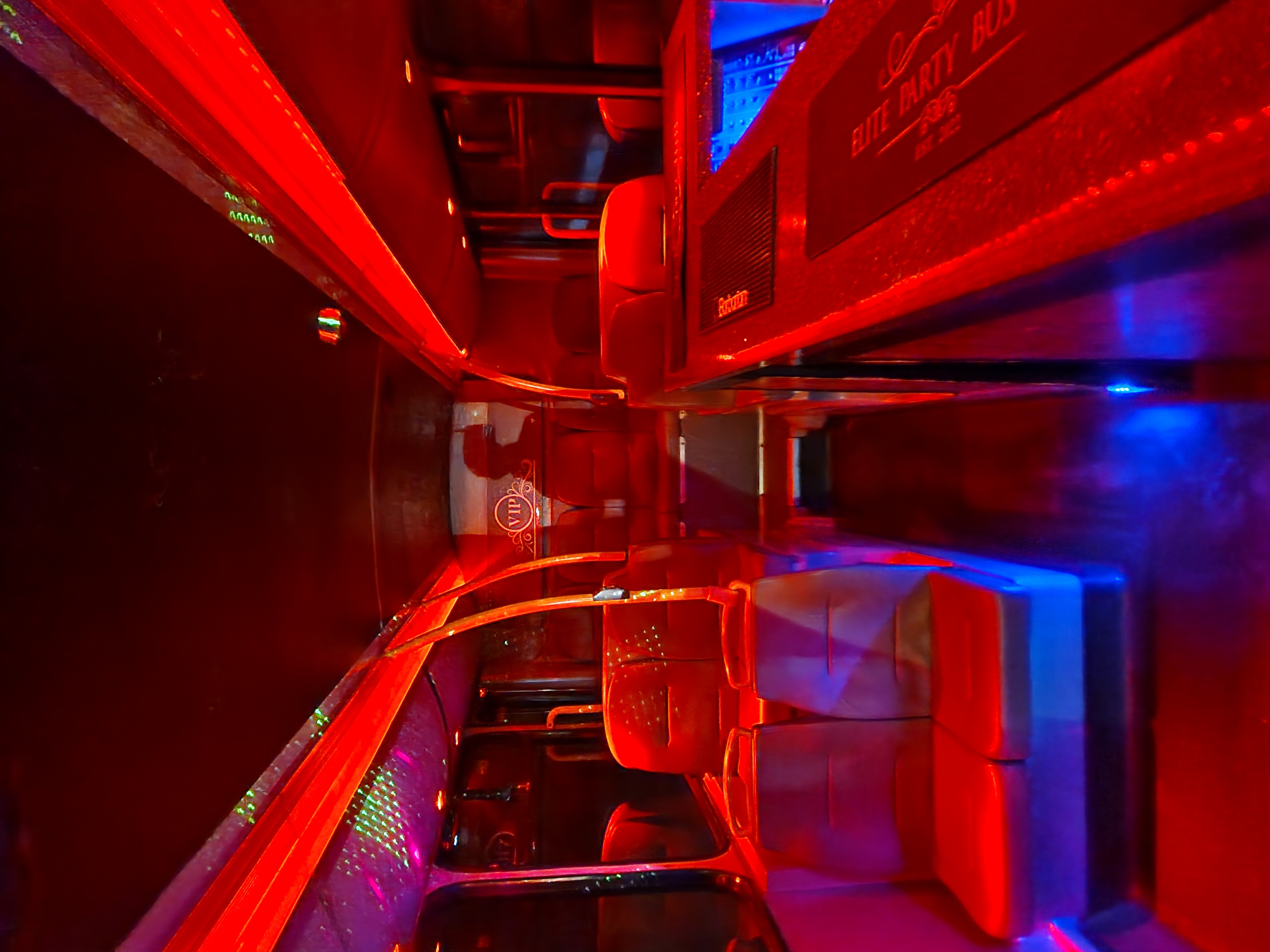 Vibrant party bus in London with red and blue lighting for corporate events and private parties.