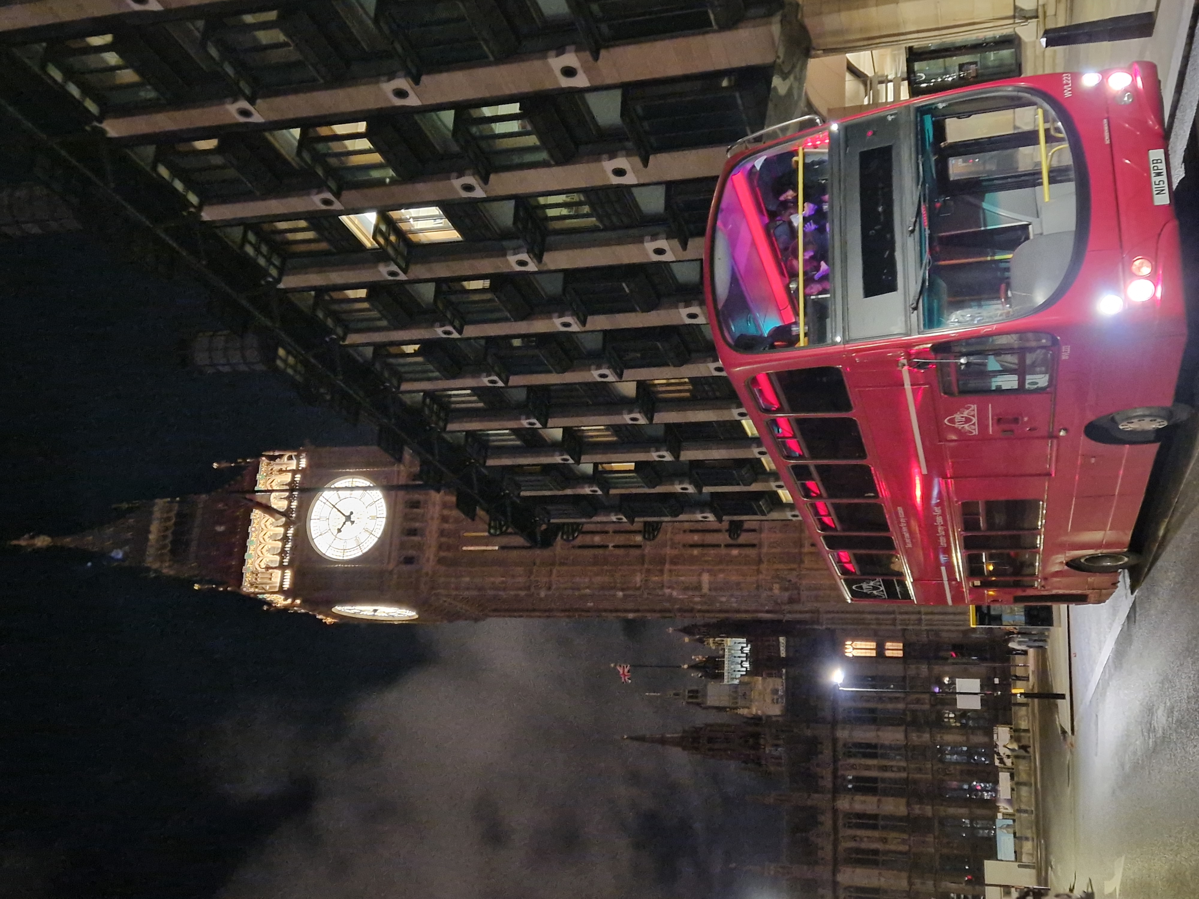 Vibrant double-decker party bus near Big Ben, ideal for events and networking in London.