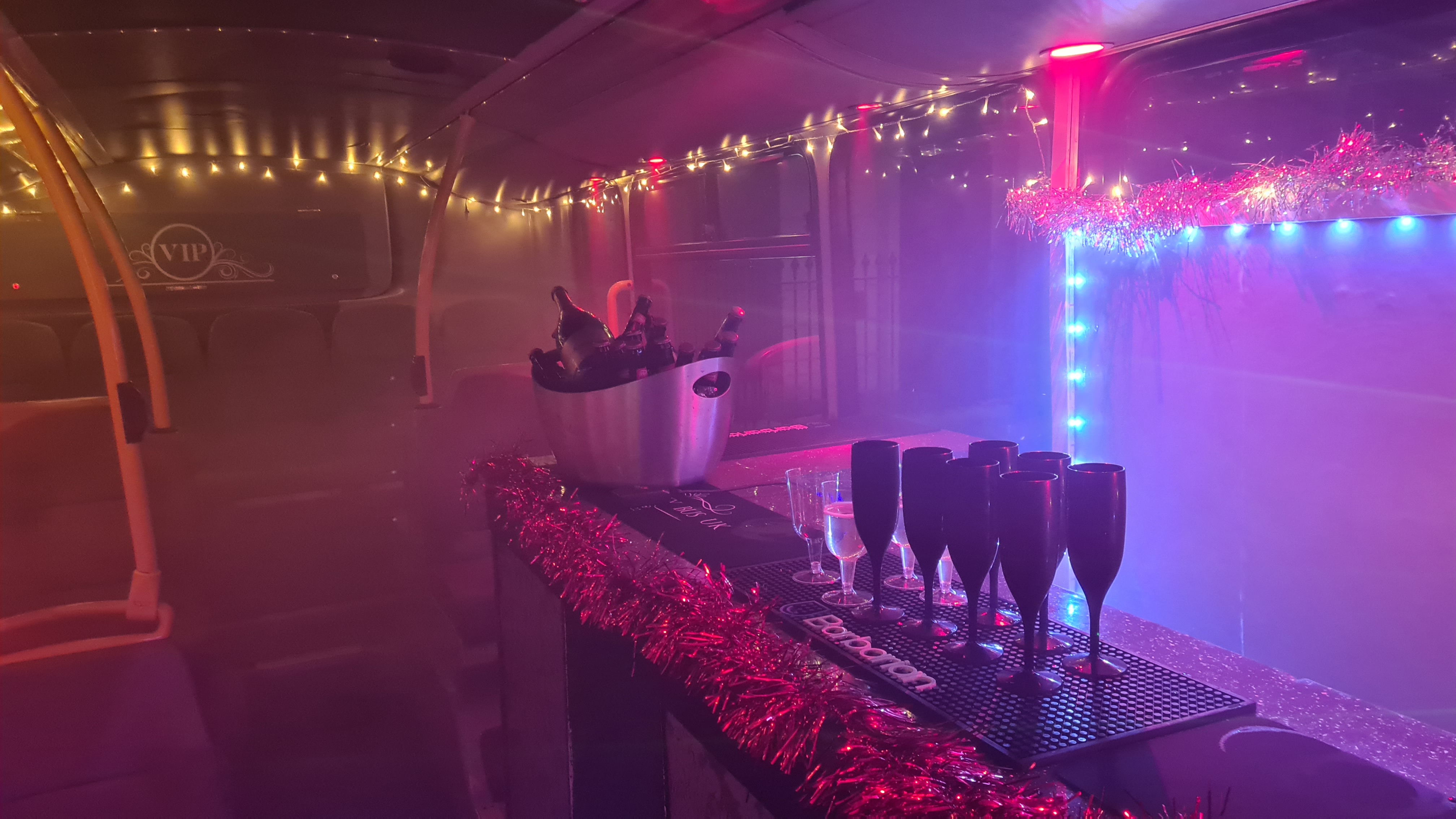 Vibrant party bus in London with stylish bar setup for unique mobile events.