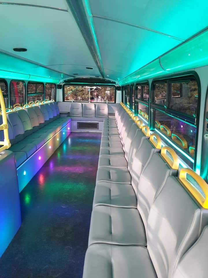 Modern party bus interior with LED lighting for events in London.