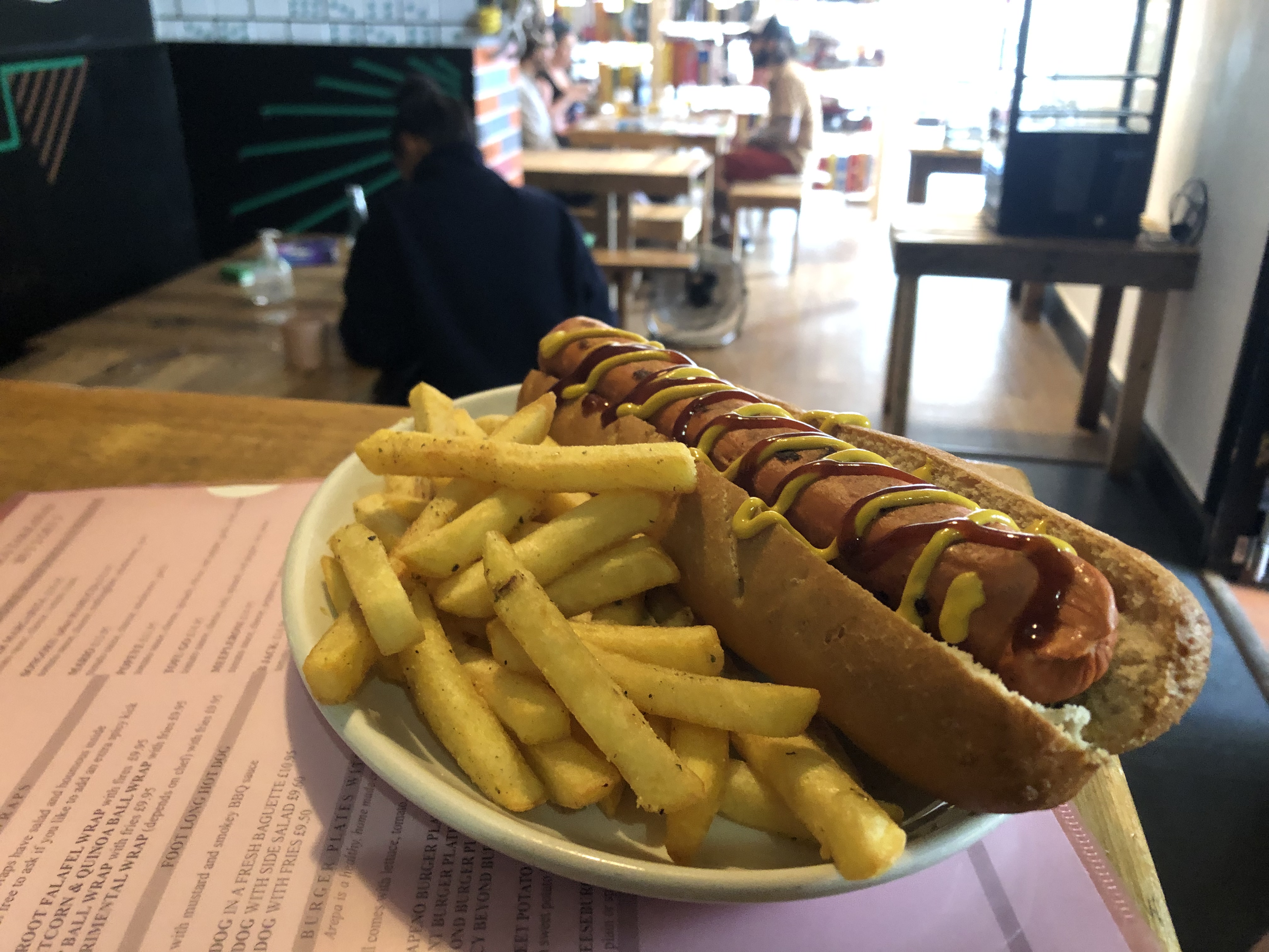 Hot dog with mustard and fries at Replay Bristol for casual event catering.