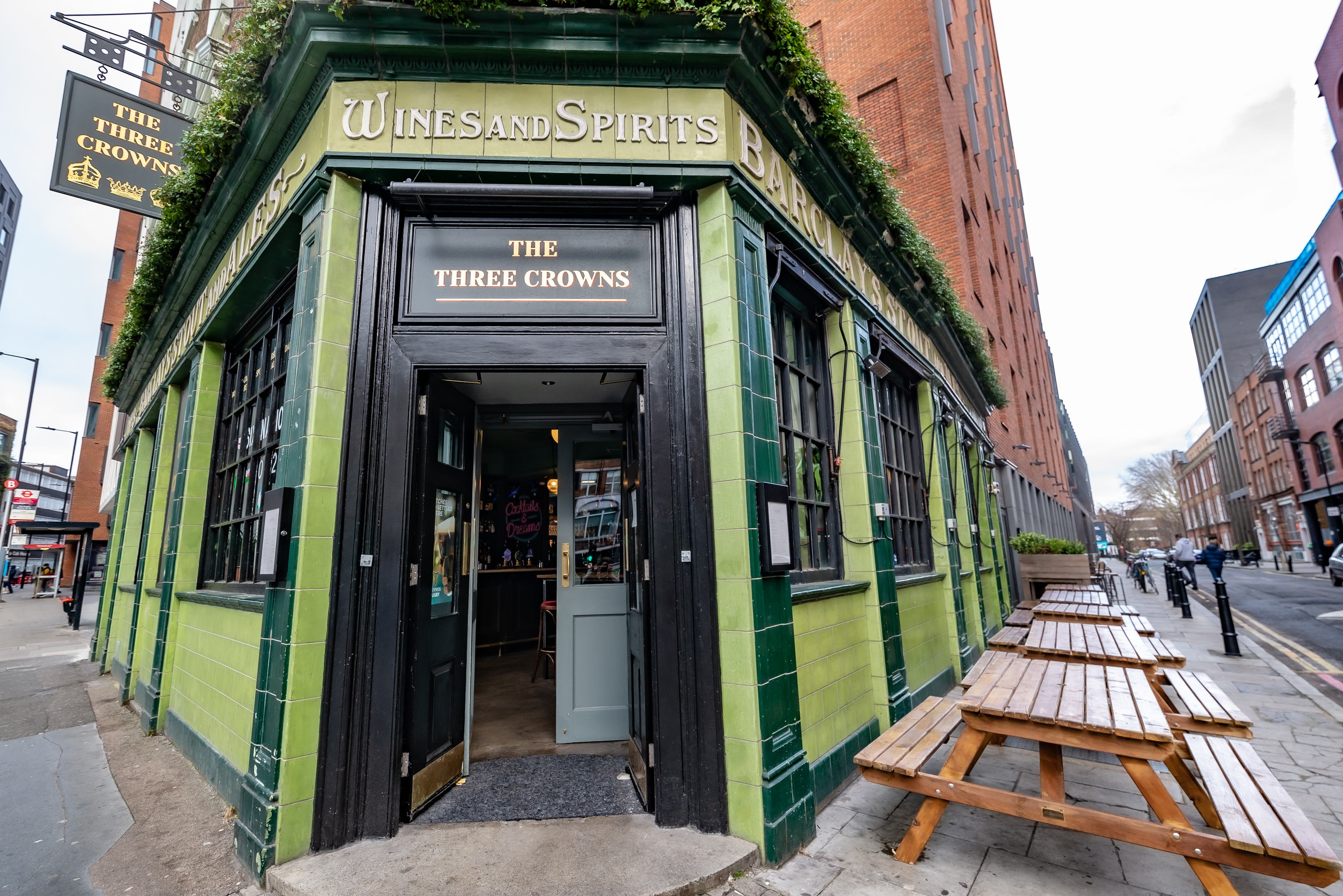 Charming pub exterior with outdoor seating, ideal for casual networking events.