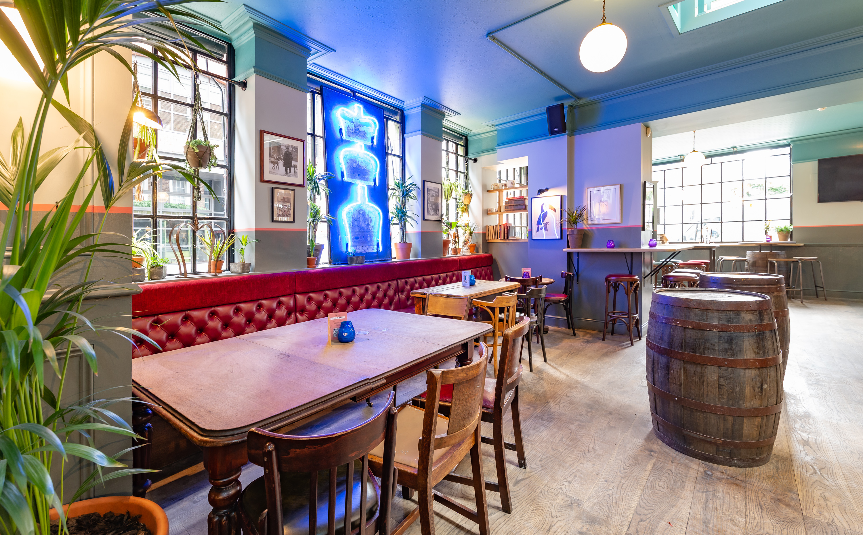 Stylish dining room with neon decor, ideal for intimate gatherings and networking events.