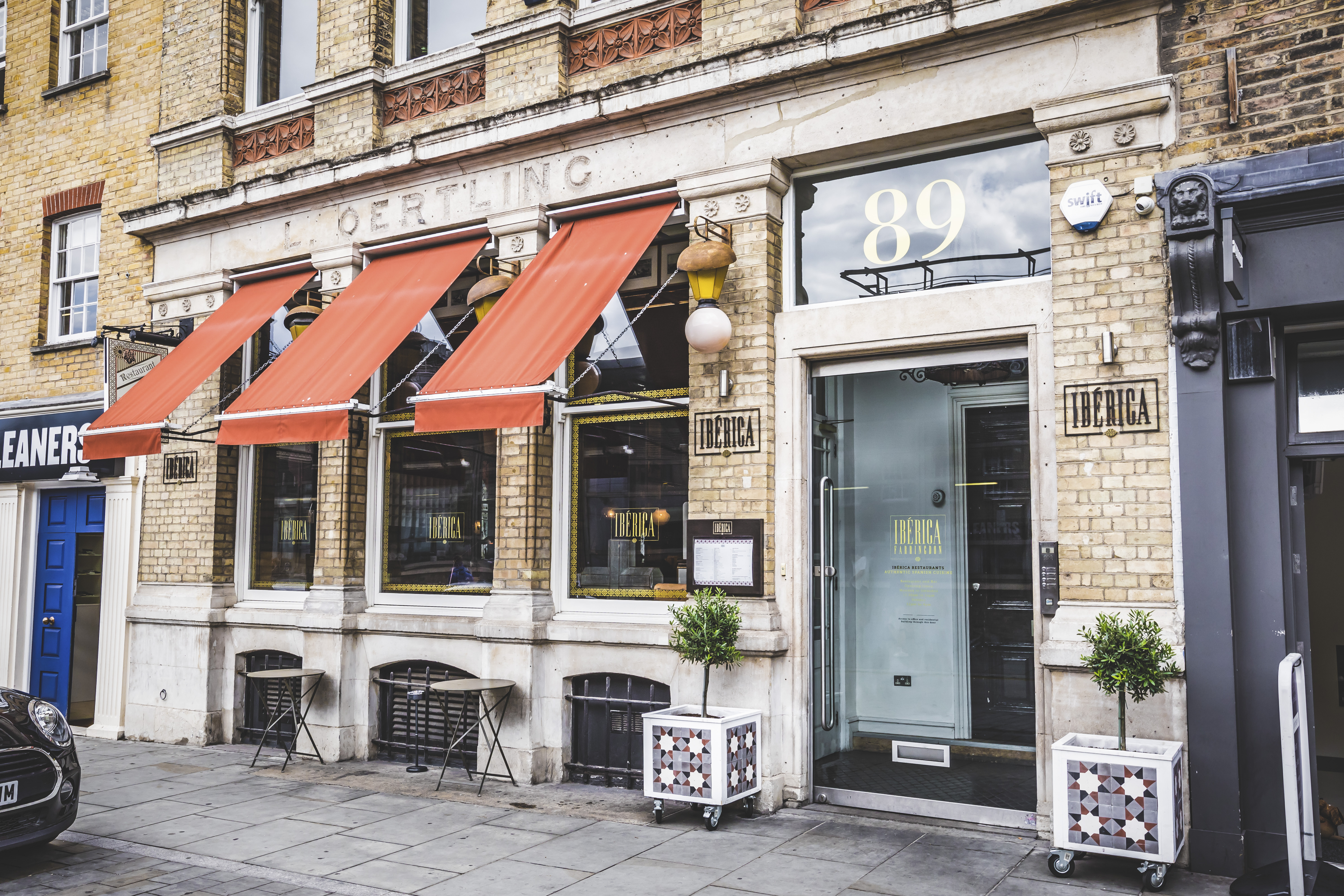 Stylish bar area with large windows, ideal for events and gatherings in Ibérica Farringdon.