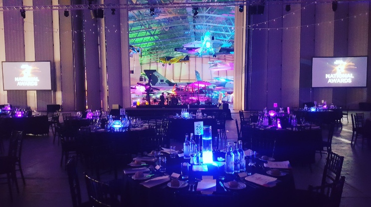 Conservation Hall at IWM Duxford set for a gala with elegant tables and aircraft backdrop.