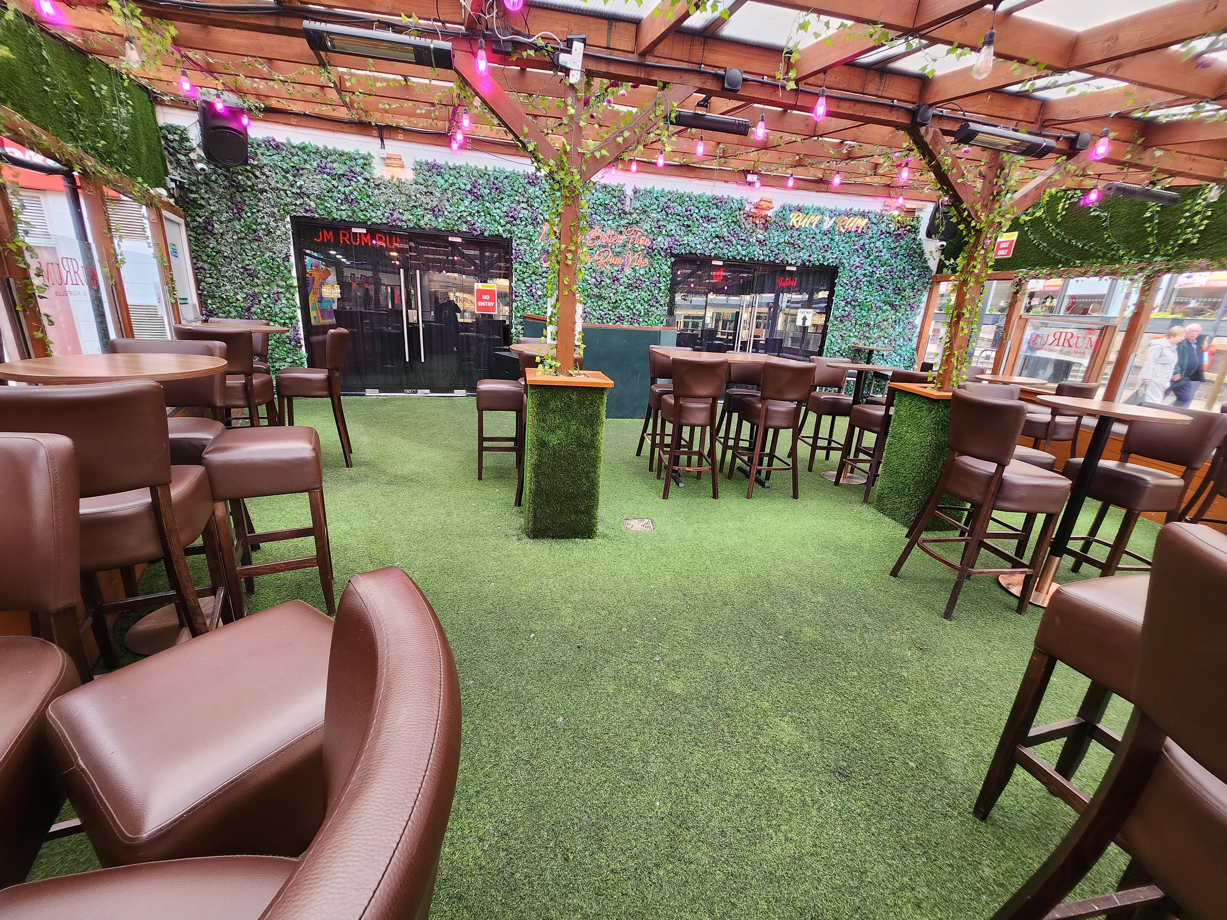 Rum Rum Bar & NightClub with green turf floor, ideal for casual gatherings and networking events.