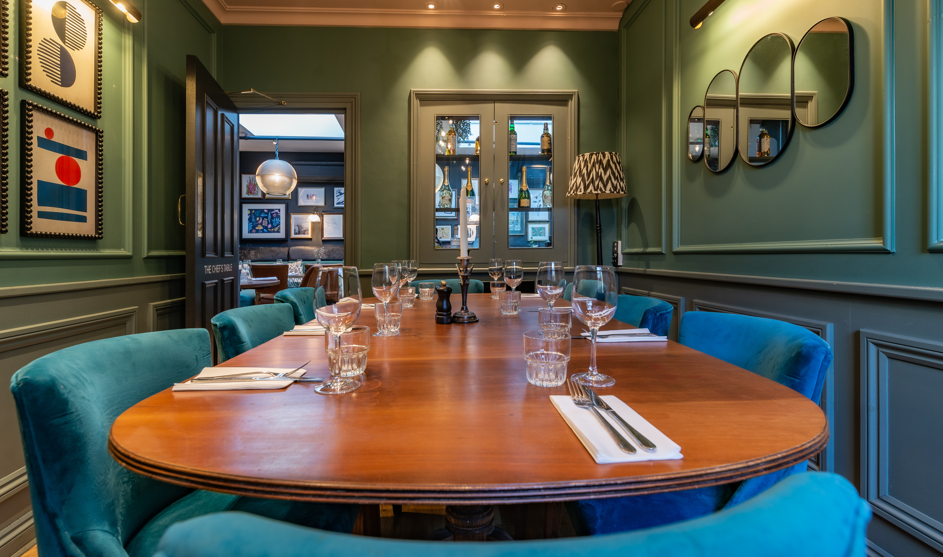 Chef's Table at The Phene: elegant meeting room with vibrant blue chairs for events.