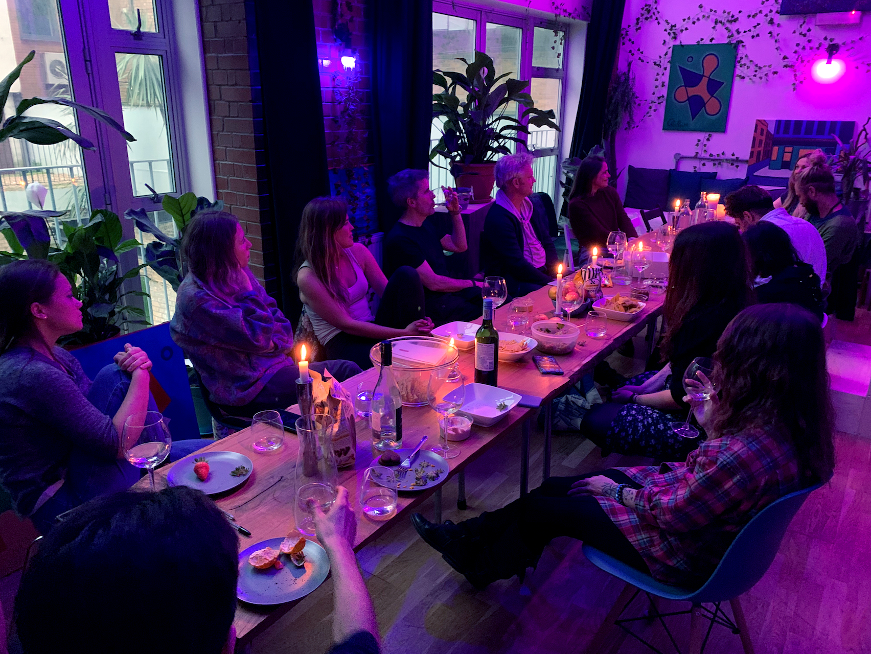 Intimate gathering at House of Transformation venue with candlelit table setup for networking.