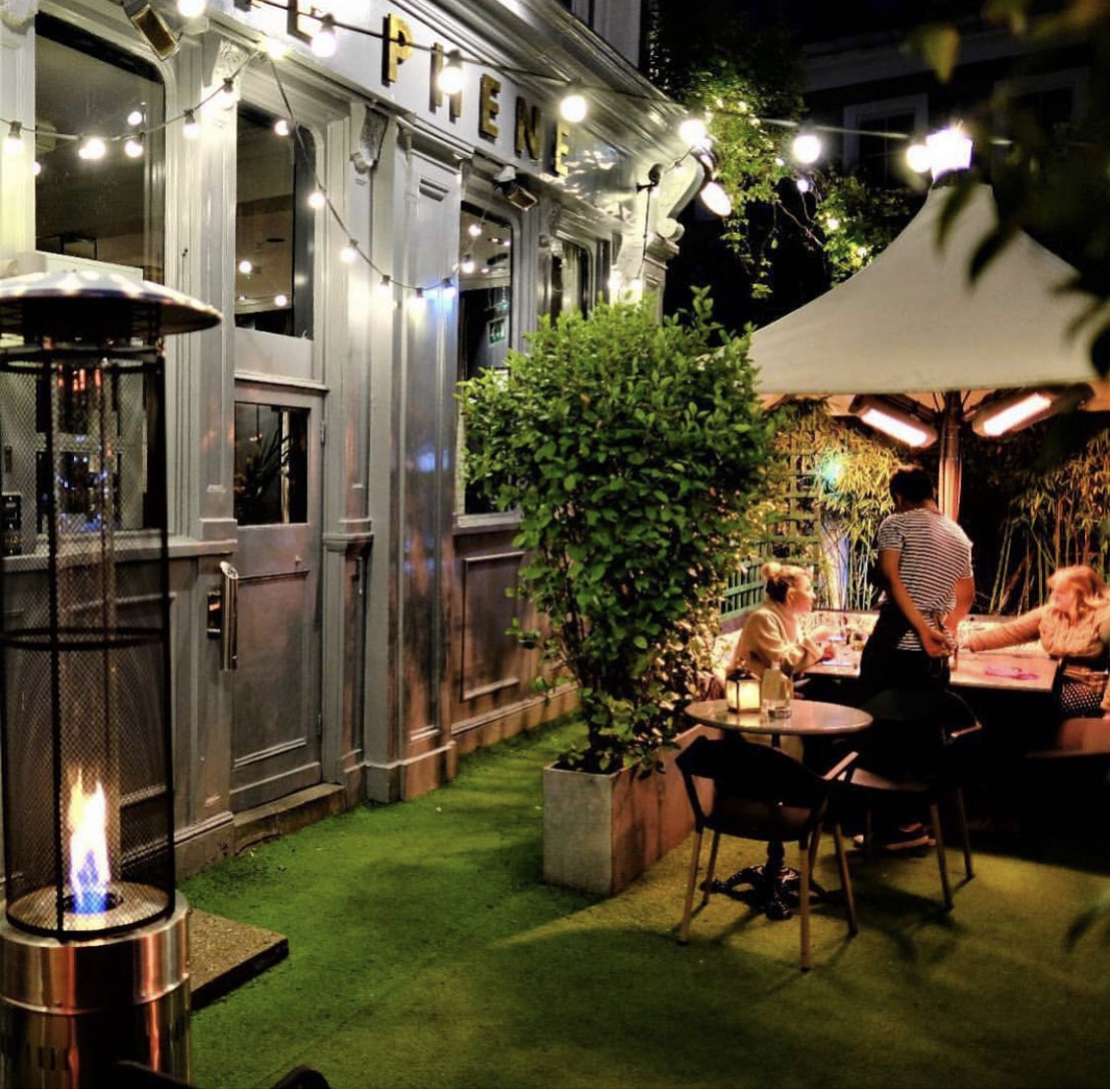 Stylish outdoor event space with greenery, perfect for intimate gatherings and networking.