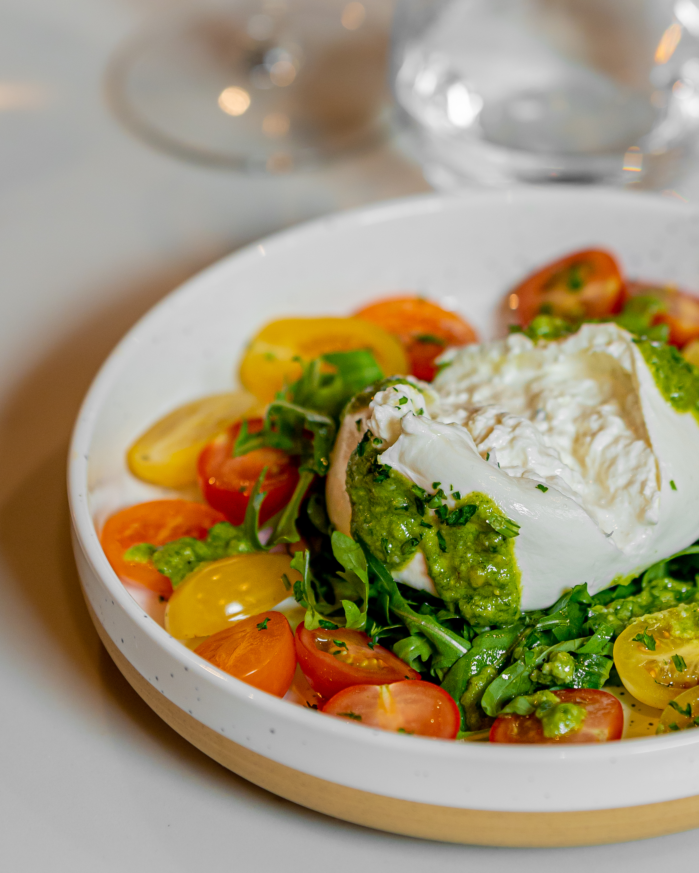 Burrata salad with heirloom tomatoes at Velvet Brasserie, perfect for upscale events.