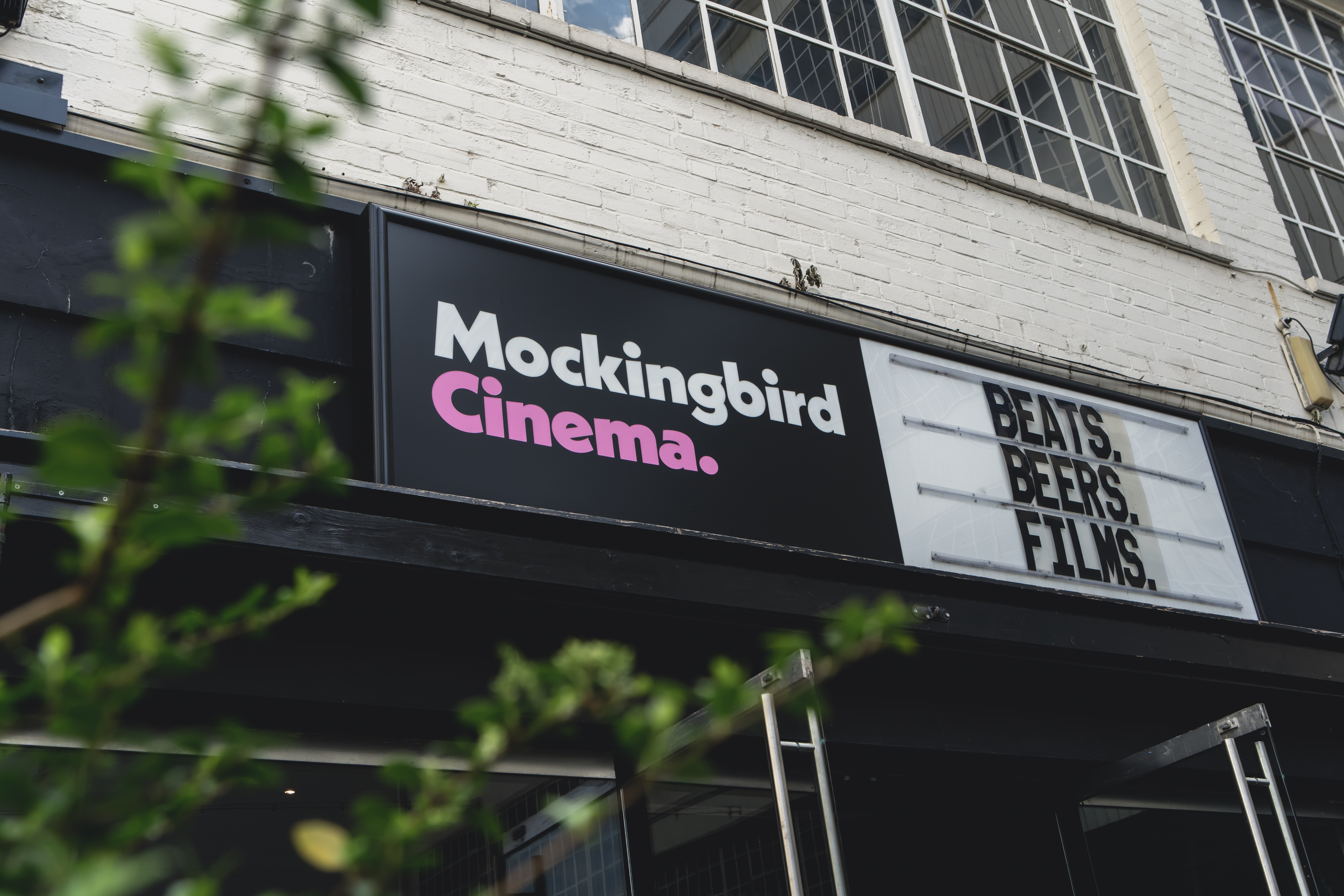 Mockingbird Cinema Bar with vibrant marquee, perfect for film screenings and events.