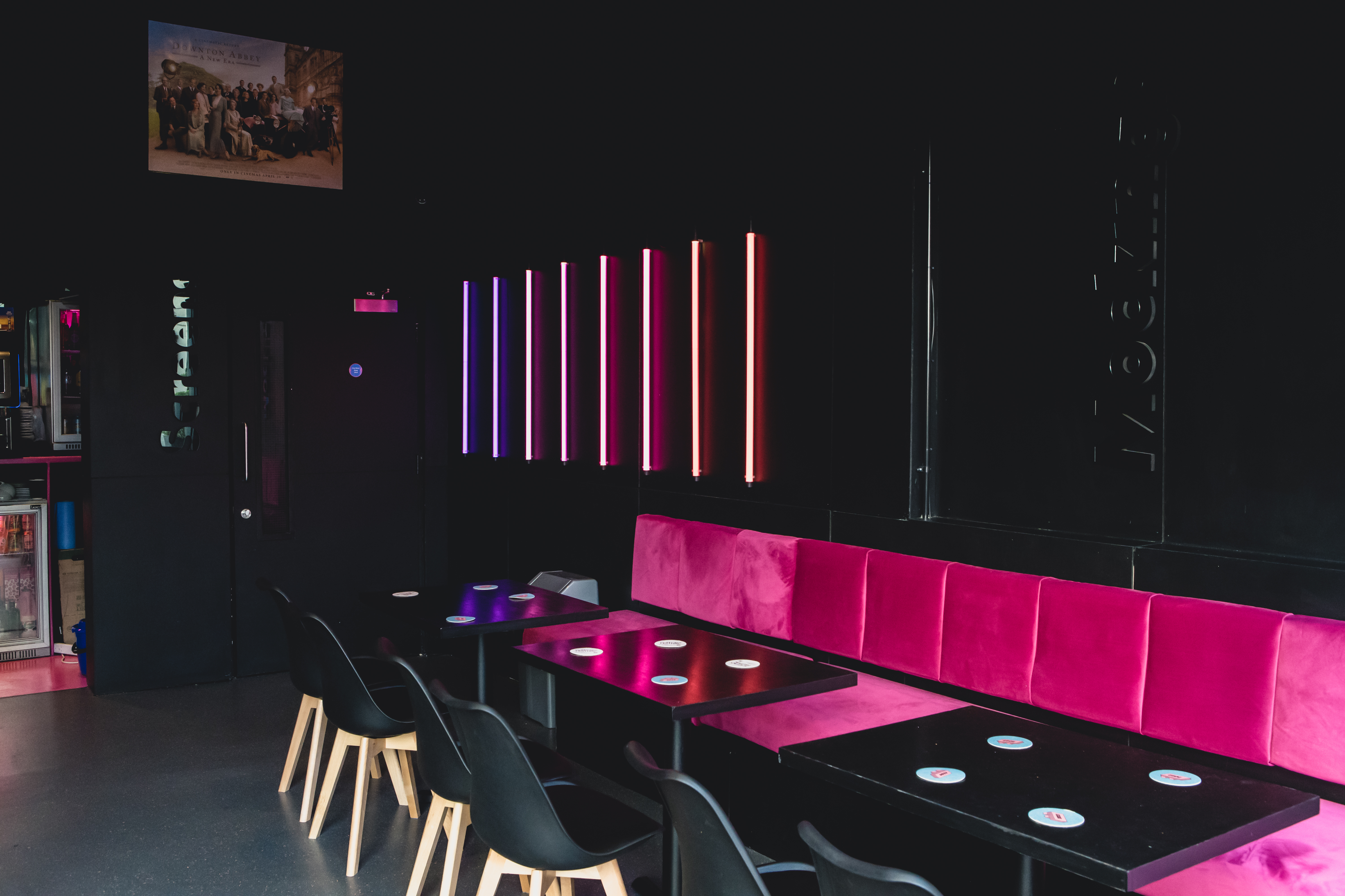 Mockingbird Cinema Bar with neon lighting and pink seating for stylish events.