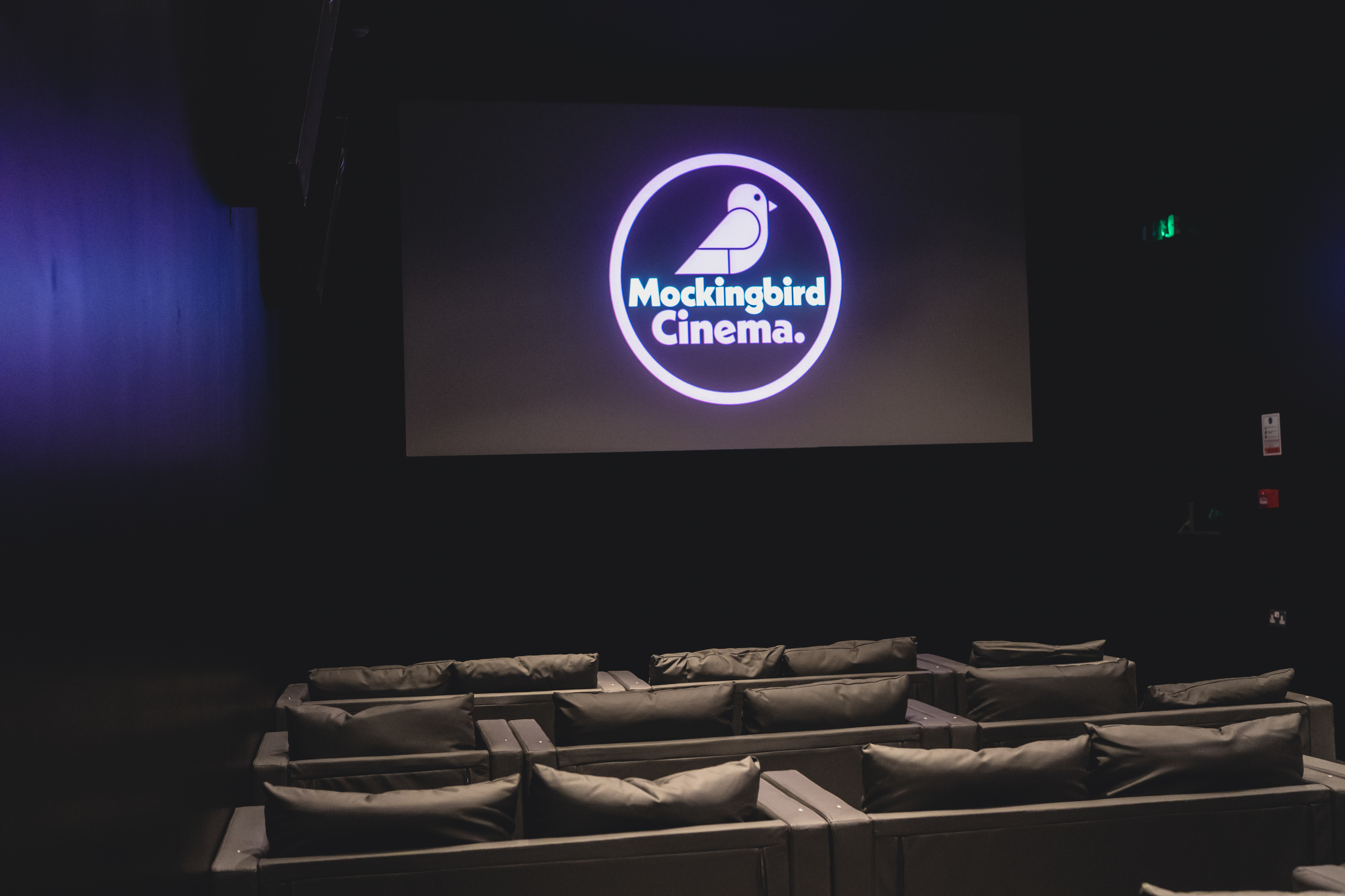 Cozy cinema seating at The Mockingbird for private events and film premieres.