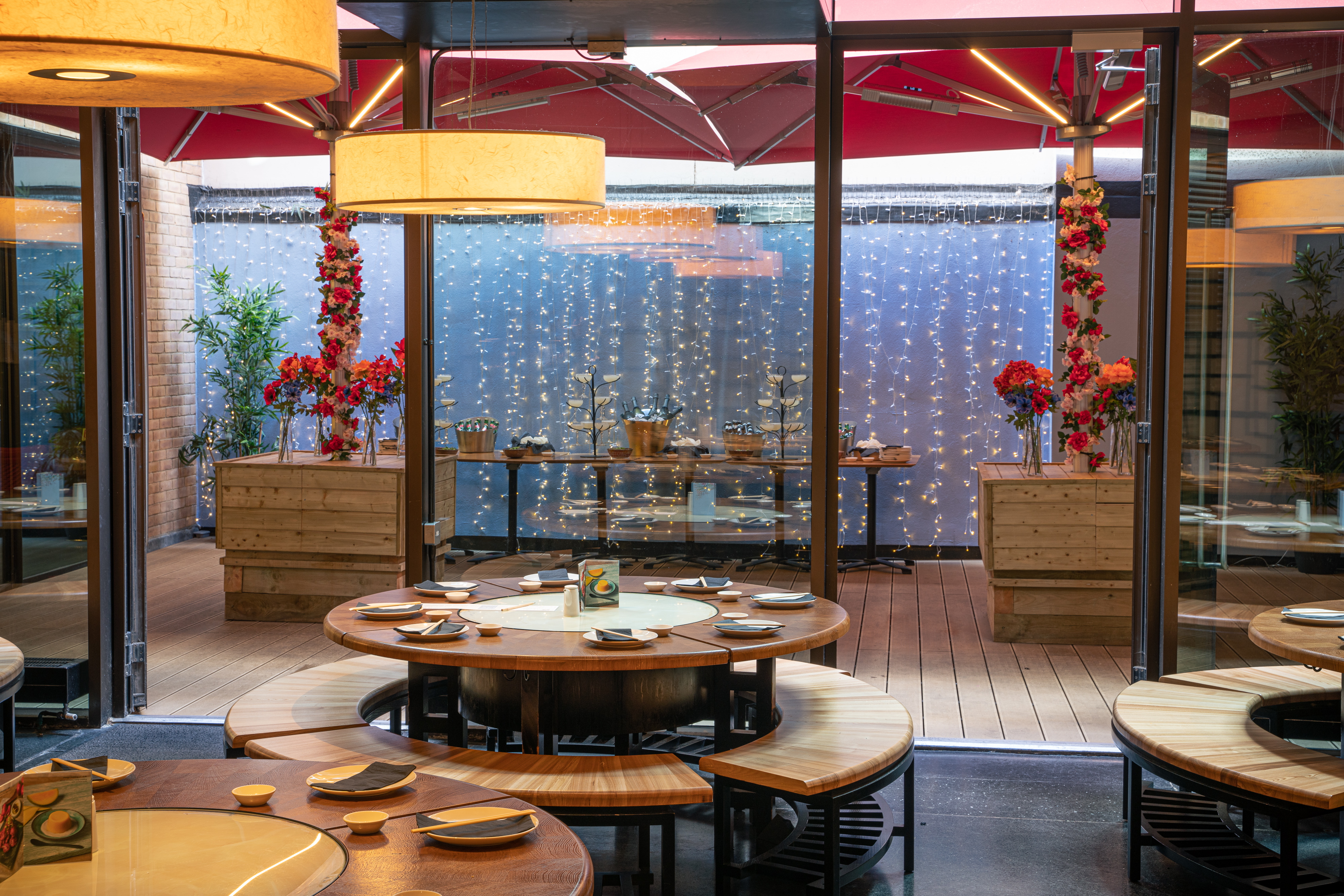 Stylish event space with circular tables and floral decor for intimate gatherings.